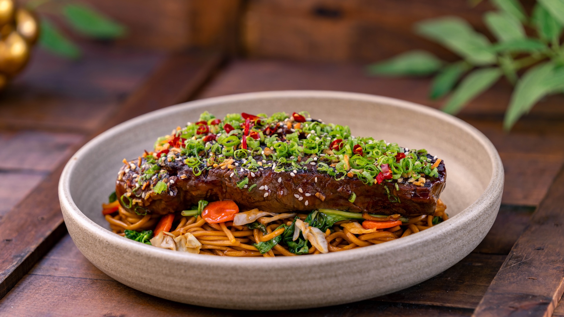 Chef&rsquo;s Special: Mongolian beef topped with green onions, sesame seeds, red chile flakes, and crispy shallots served with noodles tossed with Chinese broccoli, cabbage, and carrots (Available Jan. 23 through Mar. 5) (New)