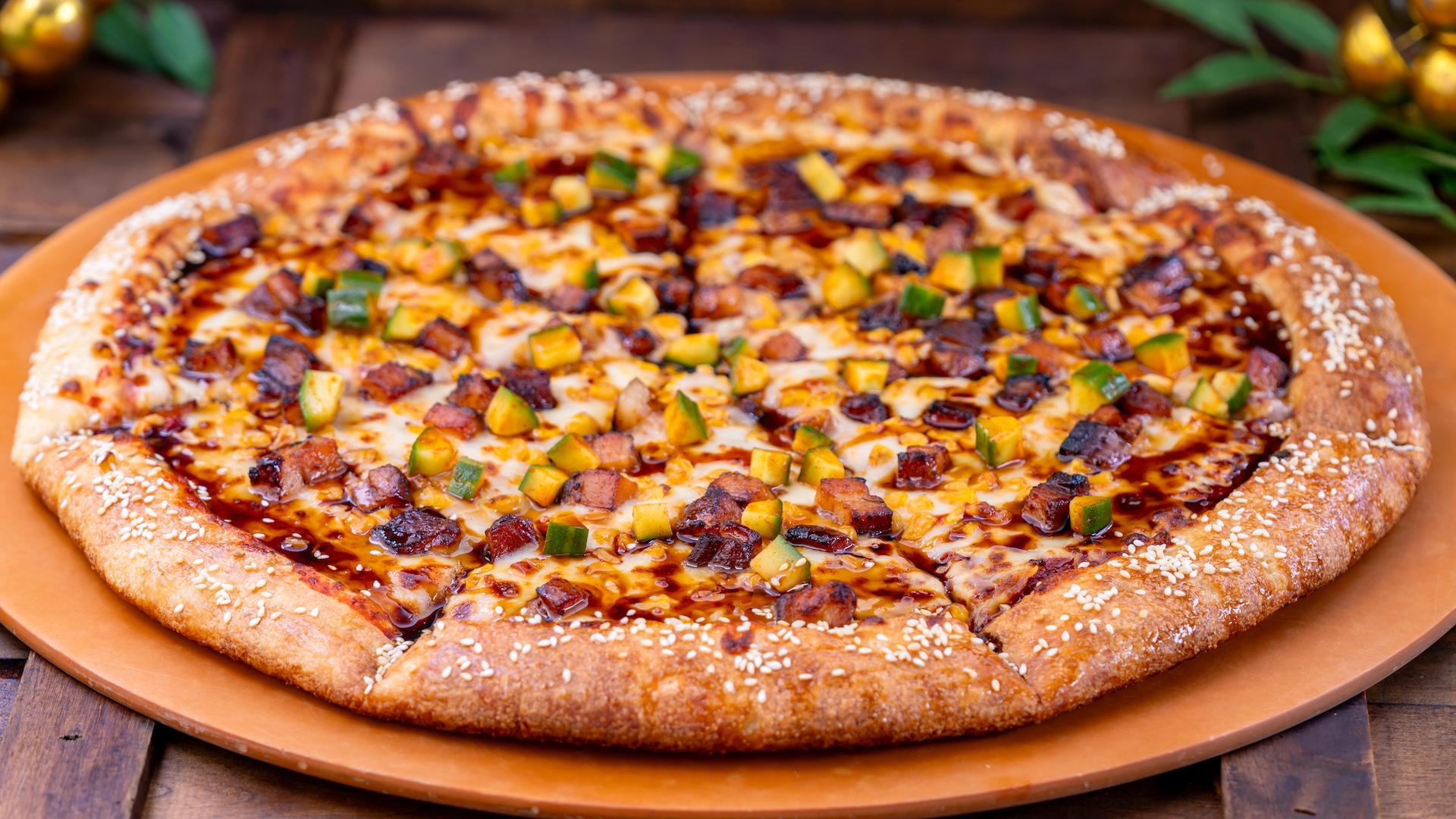 Korean Pork Belly Pizza: Roasted soy-glazed pork belly with kimchi cucumber, mozzarella, yellow corn, sesame seeds, and kimchi marinara (Available Jan. 23 through Mar. 5) (Available by slice or whole pie) (New)