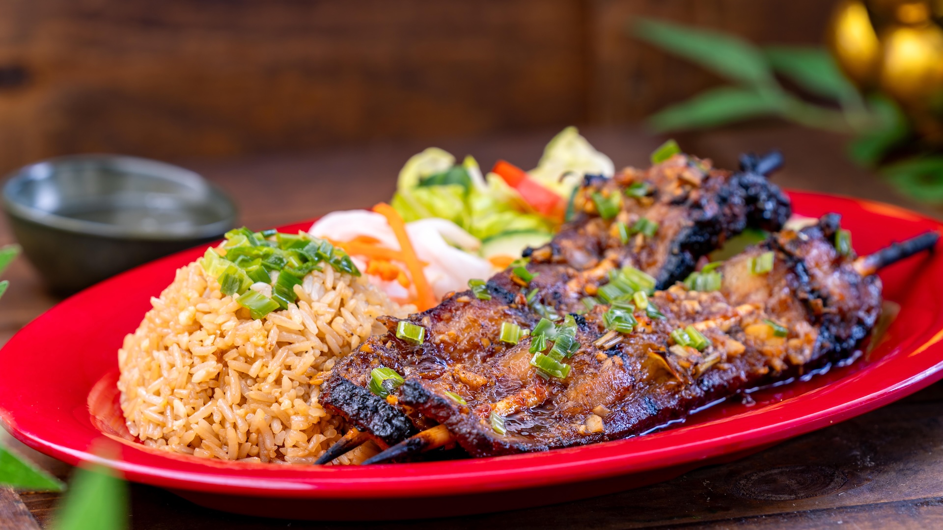 Lemongrass Pork Skewers: Grilled lemongrass-marinated pork belly skewers served with fried garlic rice, pickled carrots and daikon radish, and a side salad (Available Jan. 23 through Mar. 5) (New)