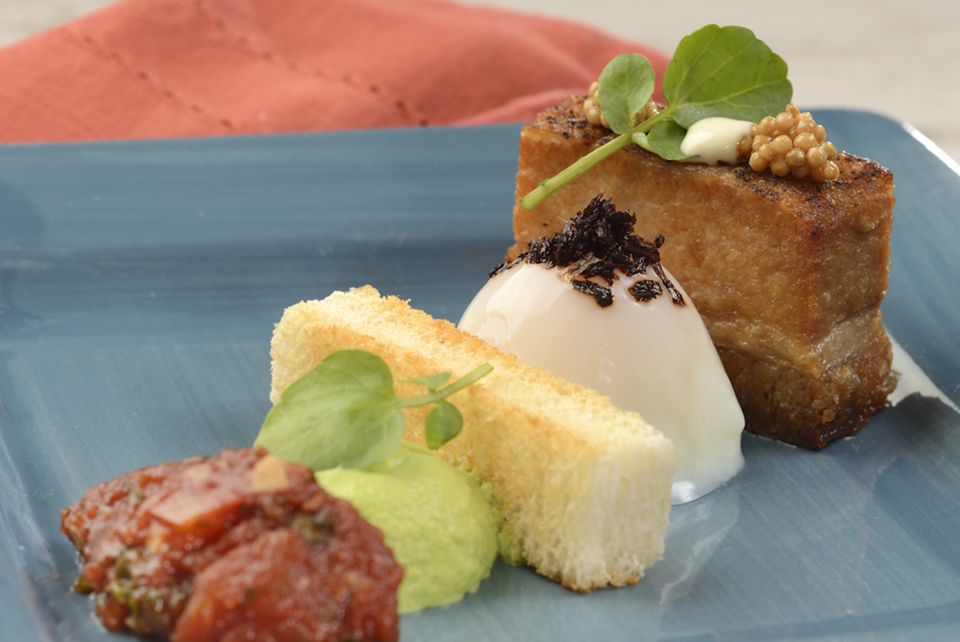 Deconstructed BLT: Pork belly, soft-poached egg, onion bread pudding, watercress espuma, and tomato jam