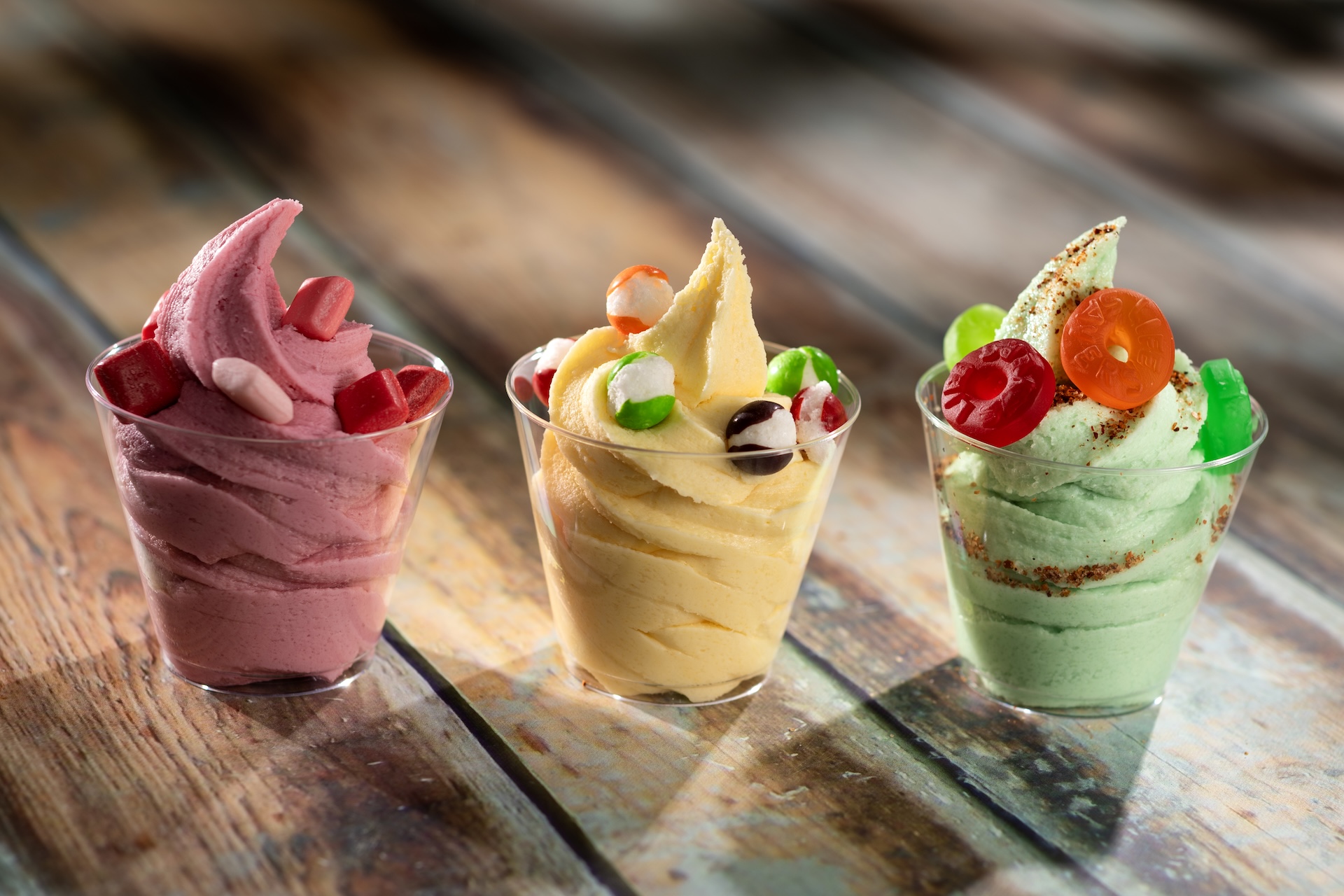 Candy Trio Flight: DOLE Whip Strawberry with STARBURST MINIS fruit chews, DOLE Whip Lemon with SKITTLES POP&rsquo;d Original Freeze Dried Candy, and DOLE Whip Lime with chili-lime seasoning and LIFE SAVERS gummies