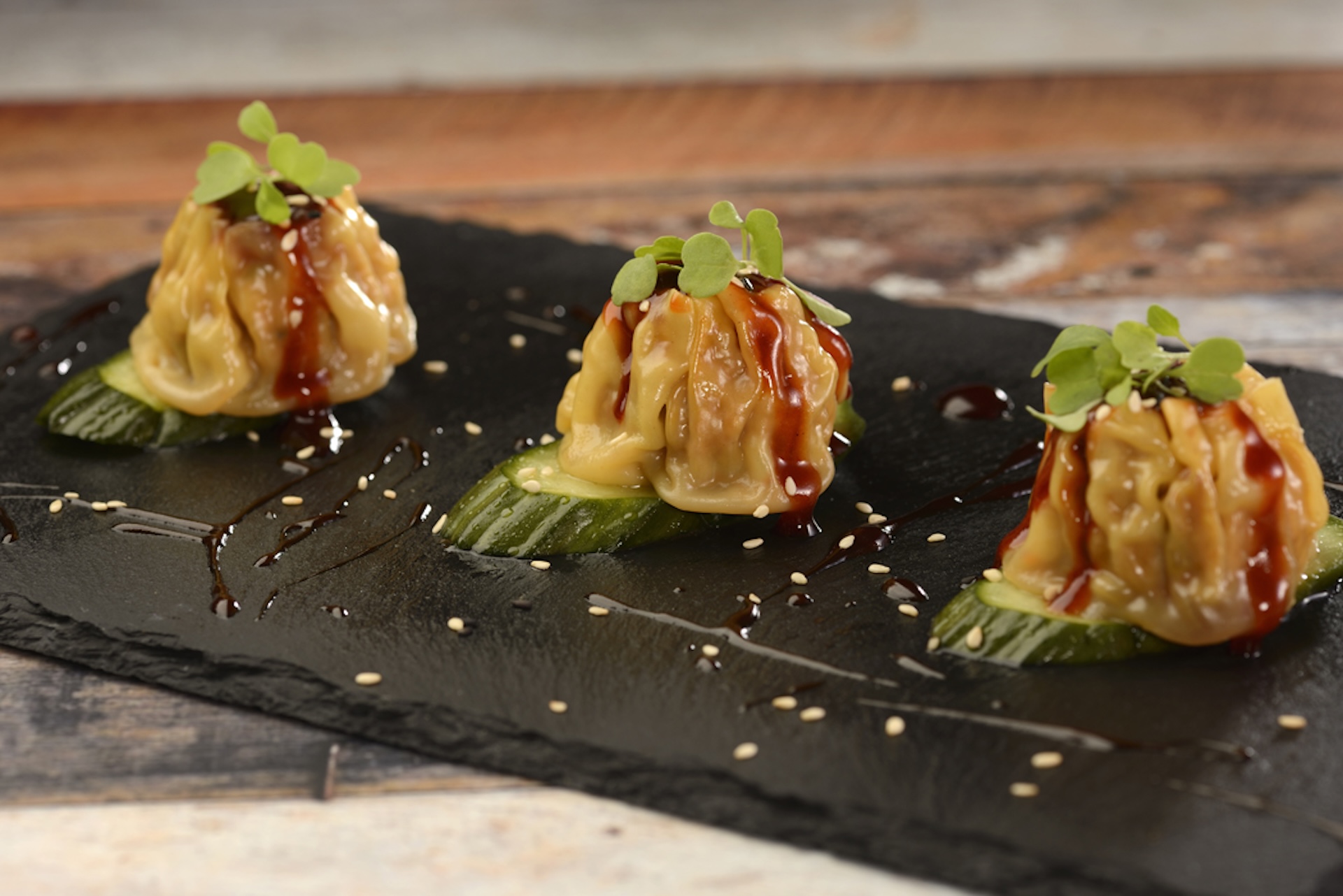 General Tso&rsquo;s Chicken Shumai: Dumplings filled with chicken, asparagus, onion, and water chestnut topped with General Tso&rsquo;s sauce (New)