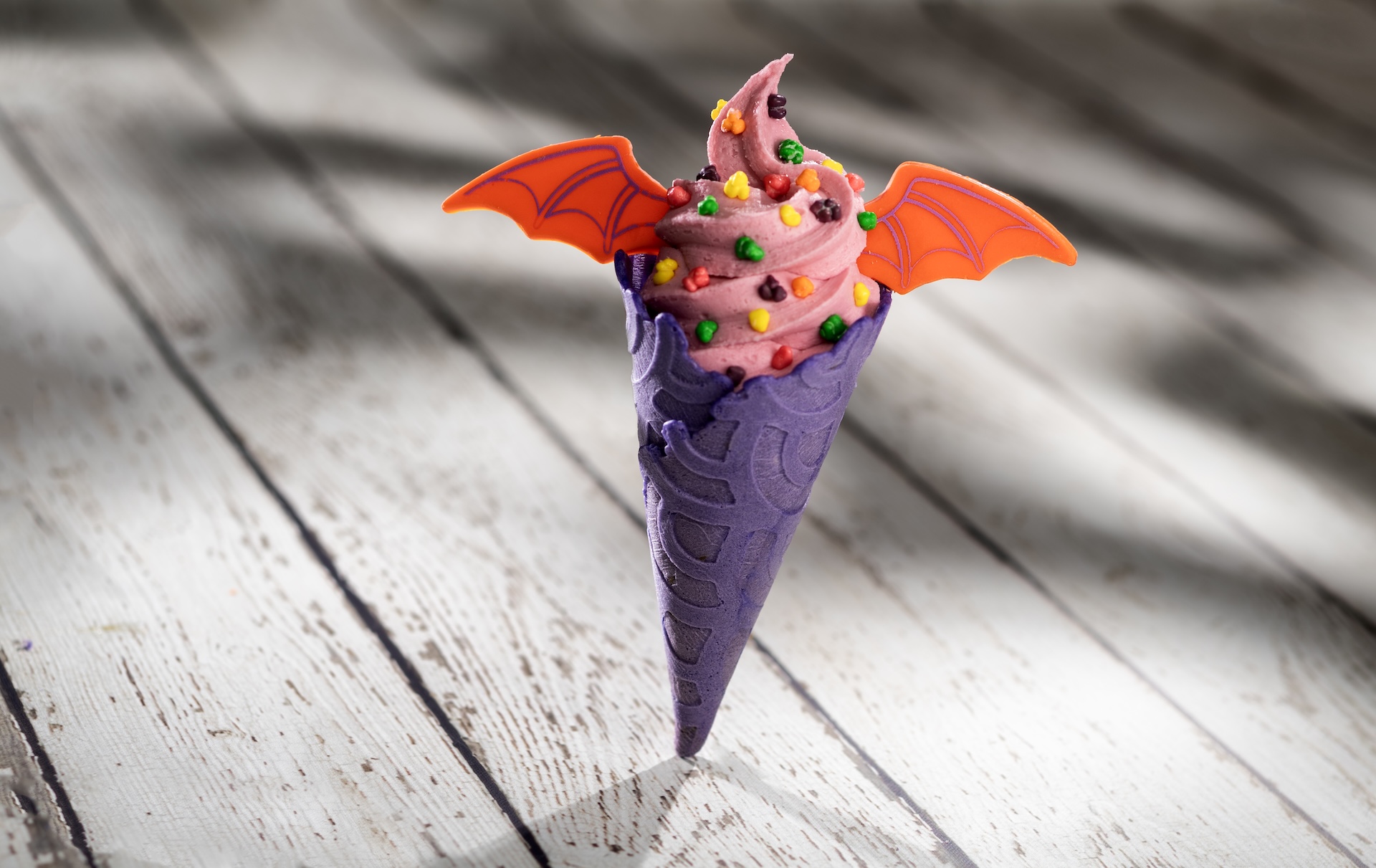 Imagination Cone: Pink vanilla soft-serve in a lavender cone, &ldquo;sparks&rdquo; of imagination, and white chocolate Figment wings