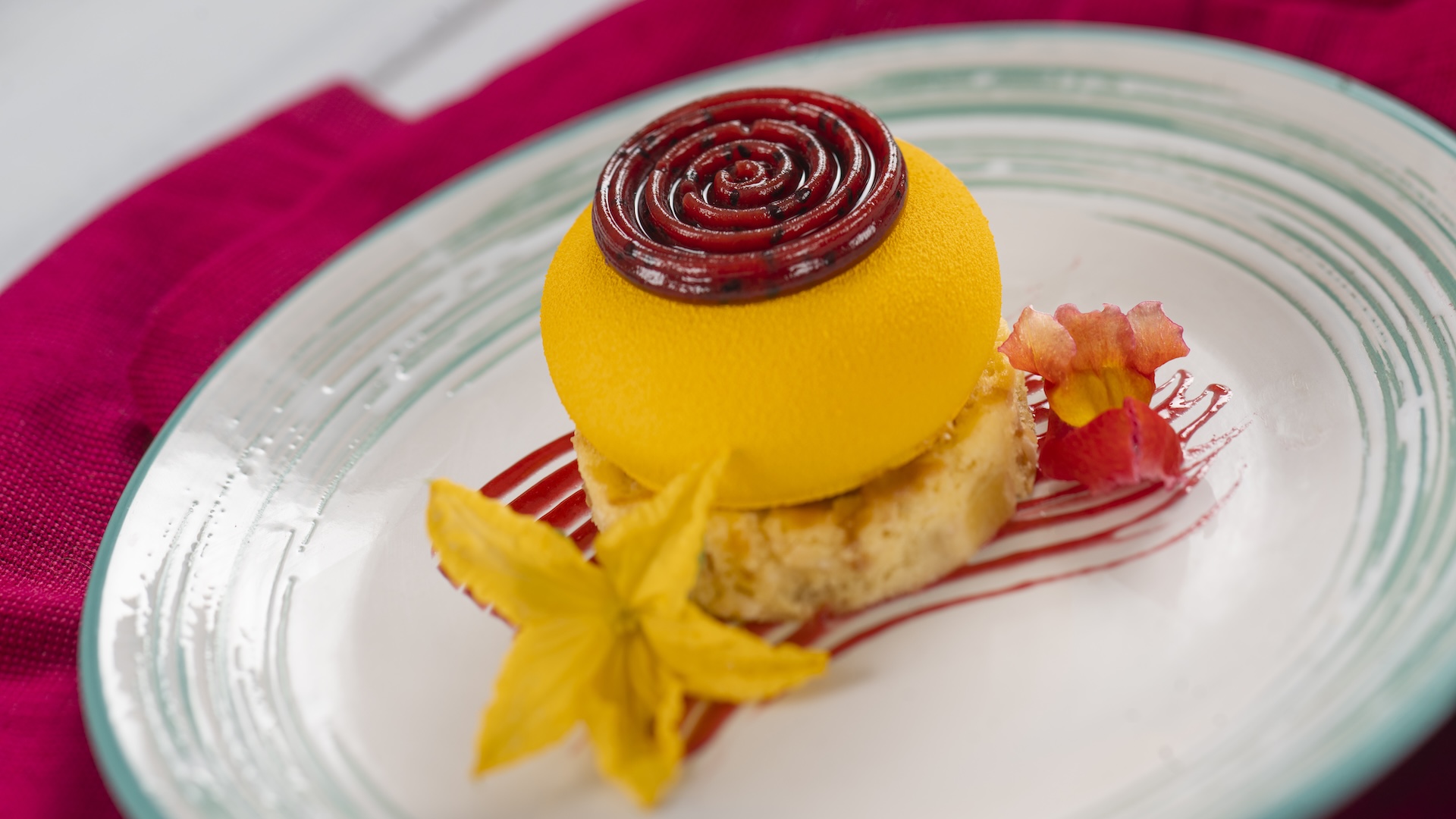 Passion Fruit-filled Mango Cheesecake with coconut-pineapple cake, dragon fruit gel&eacute;e, and dragon fruit-strawberry sauce