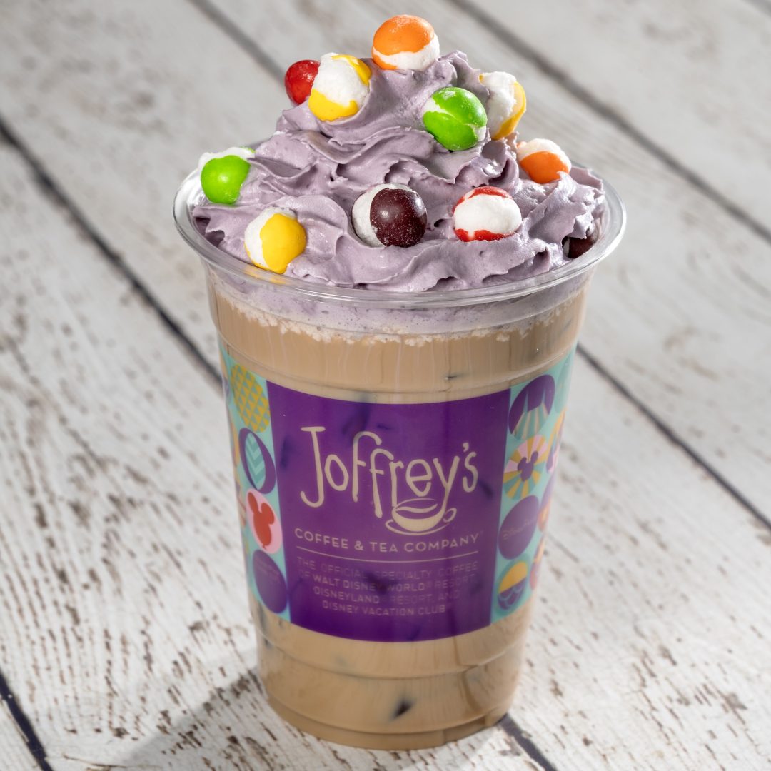 Pop Art Latte: Espresso with choice of milk and vanilla syrup topped with lavender whipped cream and SKITTLES POP&rsquo;d Original Freeze Dried Candy (Non-alcoholic beverage) (Spirited version available with Baileys Original Irish Cream Liqueur) (New)