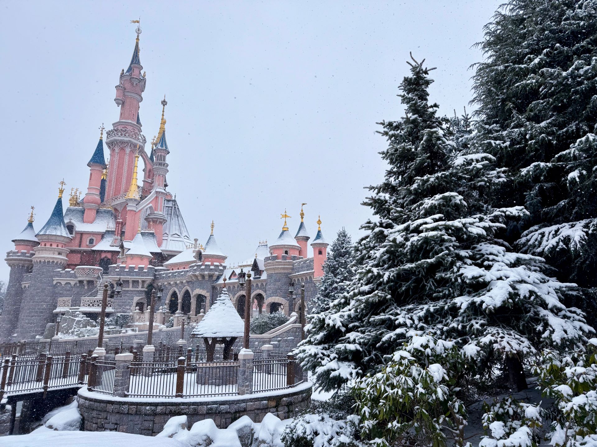 Side View of Sleeping Beauty Castle Covered in Snow