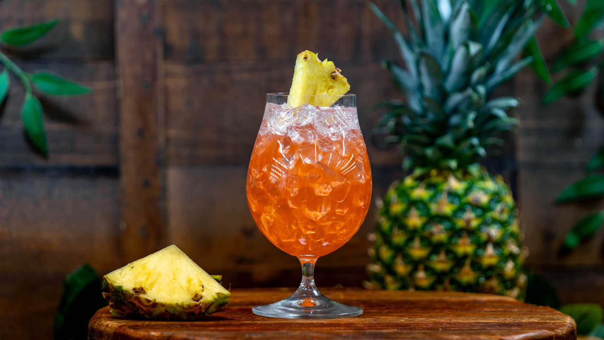 Tiki Spritz: Dark rum, Italian aperitif, pineapple juice, guava nectar, guava syrup, and sweet and sour topped with Sprite and garnished with a pineapple wedge (New)