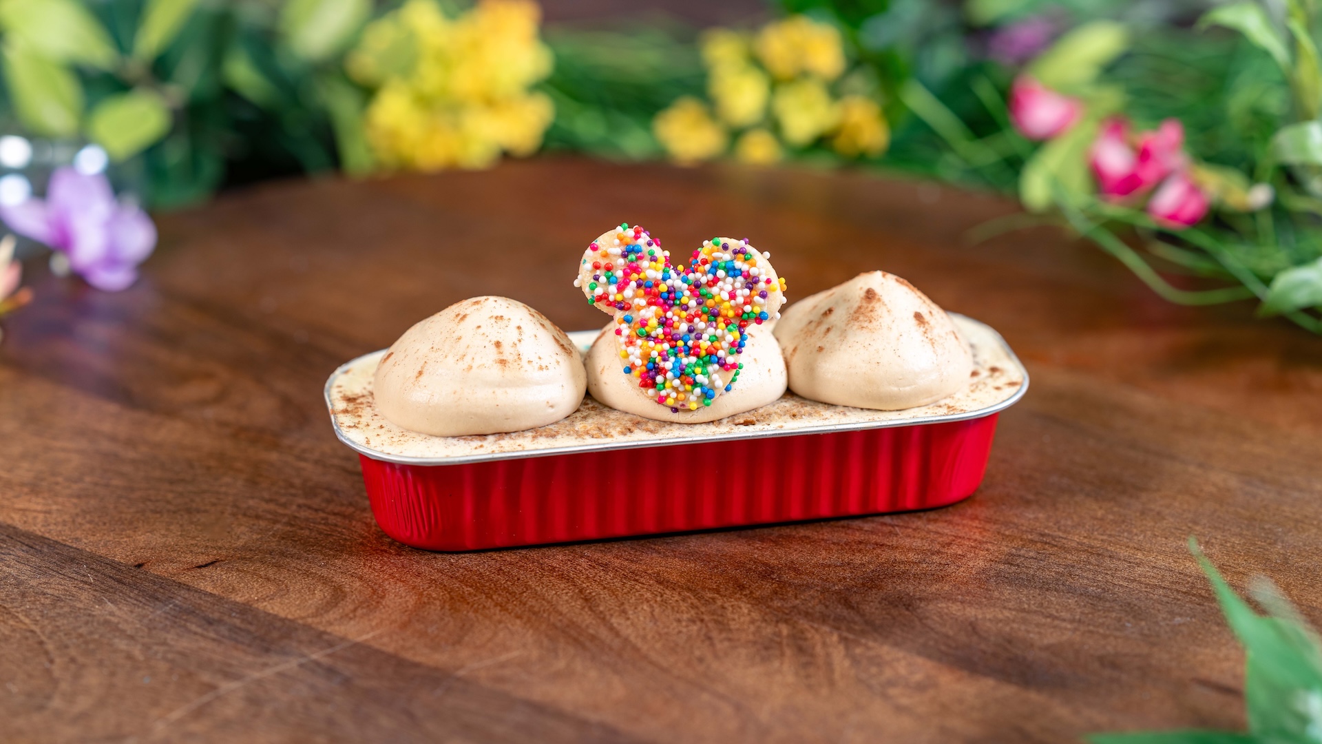 Caf&eacute; de Olla Tres Leches Cake: Caf&eacute; de olla-infused tres leches topped with piloncillo, chantilly, cinnamon, and a Mickey-shaped cookie