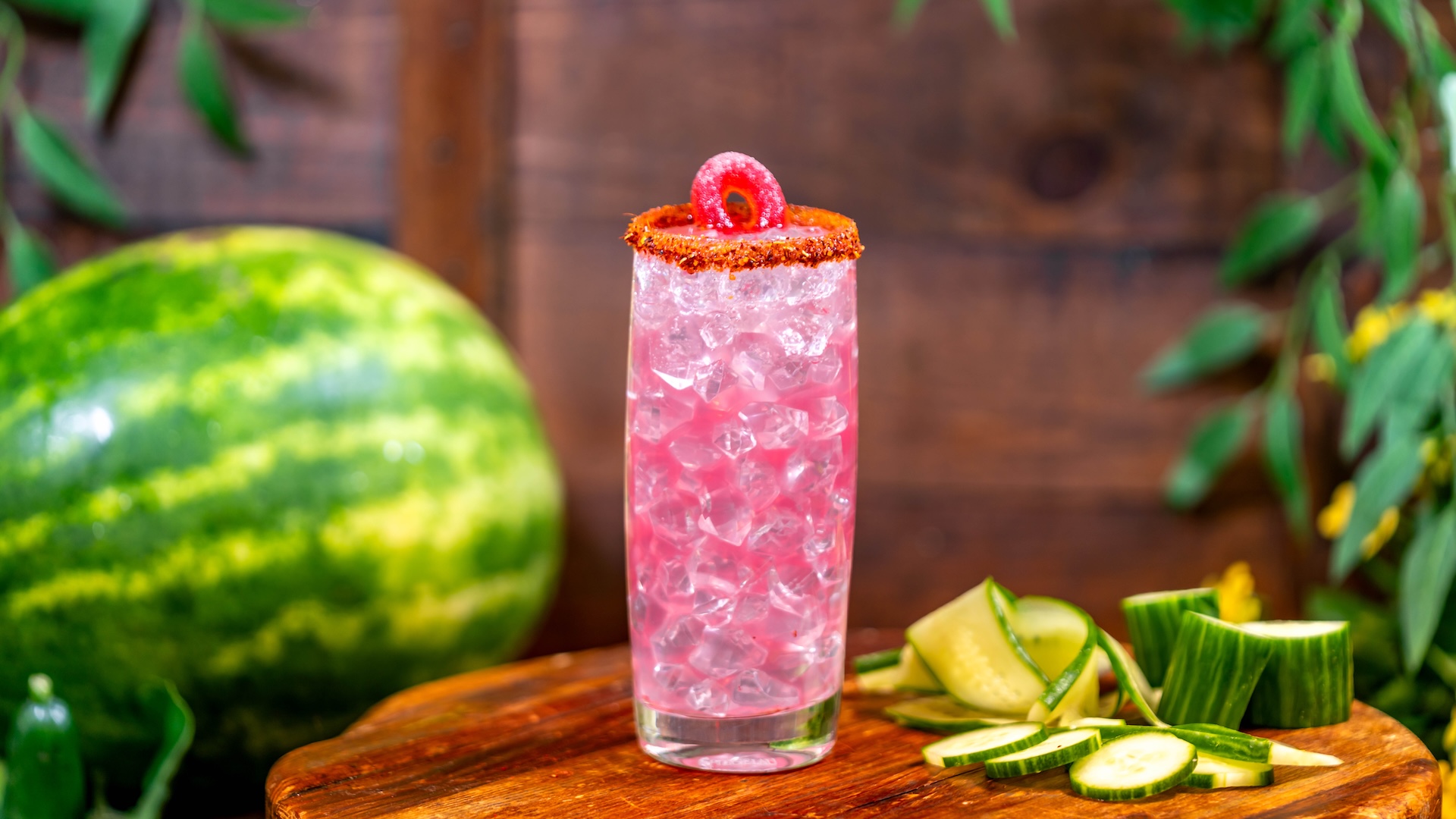 Watermelon Cucumber Mojito: White rum, watermelon liqueur, mojito and cucumber syrups, watermelon pur&eacute;e, and lime juice topped with Topo Chico and garnished with a watermelon gummy wedge and Taj&iacute;n twist