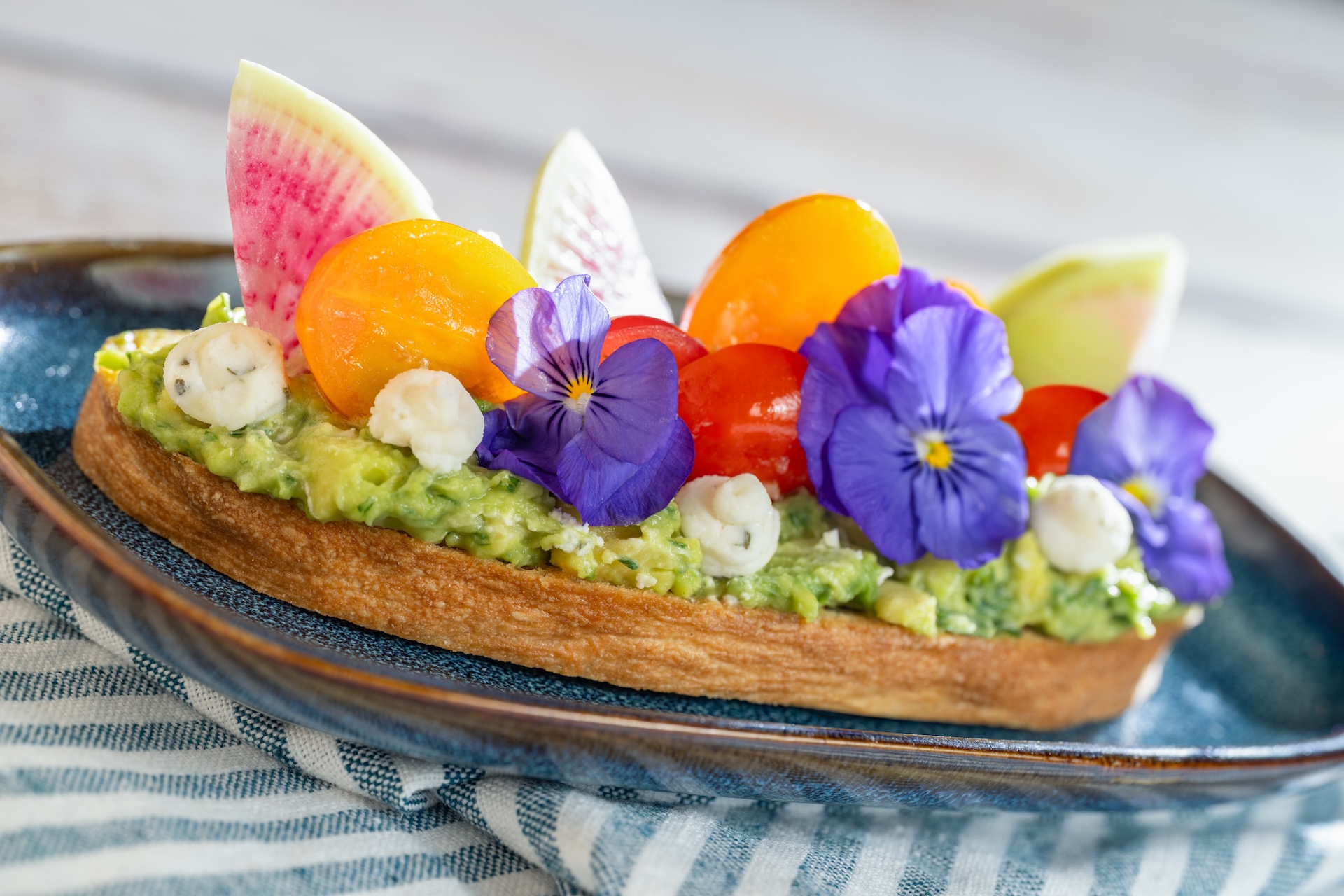 Avocado Toast with marinated tomatoes featuring Boursin Dairy-Free Garlic & Fine Herbs Cheese on toasted ciabatta (Plant-based)