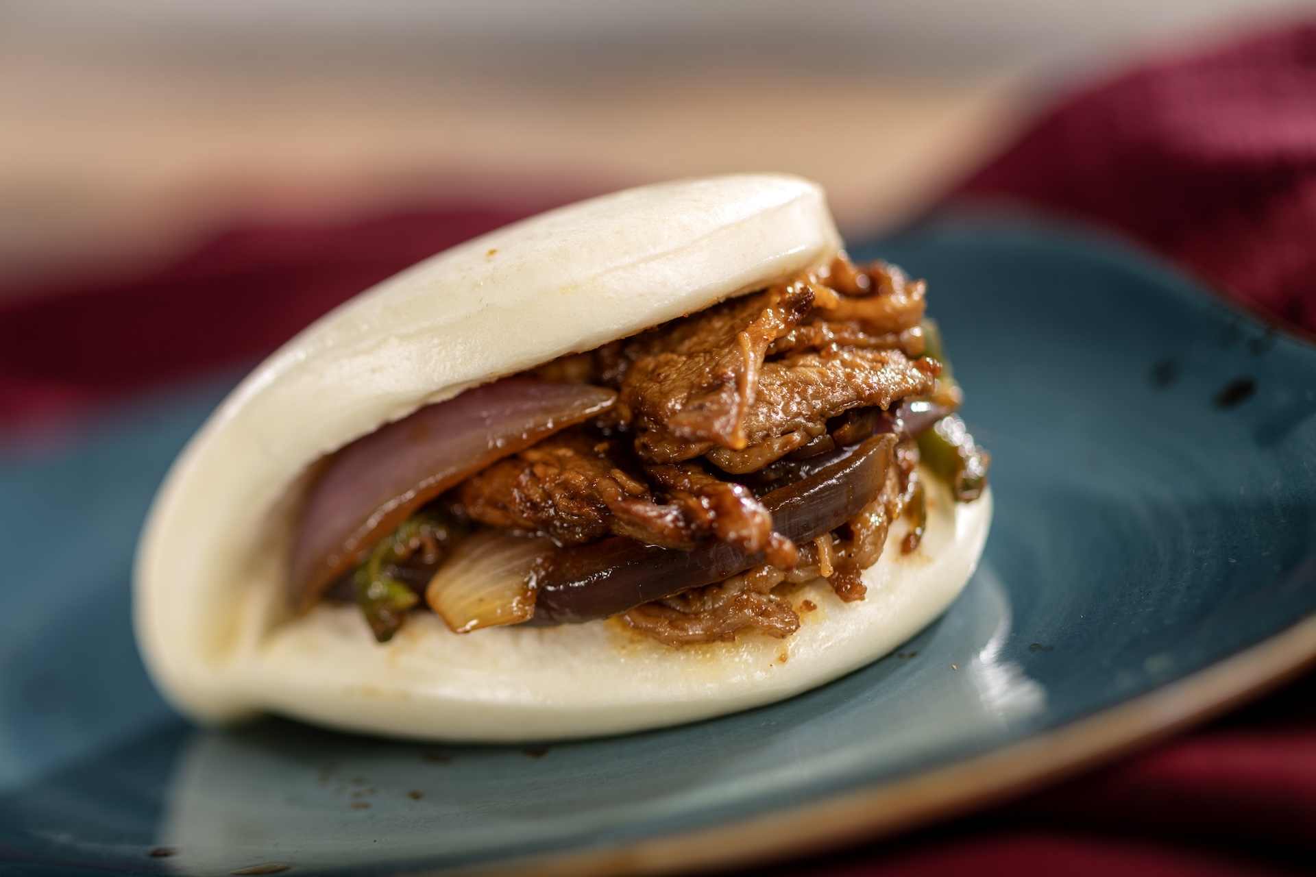 Sha Cha Beef Bao Bun filled with pan-fried beef, red onion, and jalape&ntilde;o in Chinese sha cha peanut sauce (New)