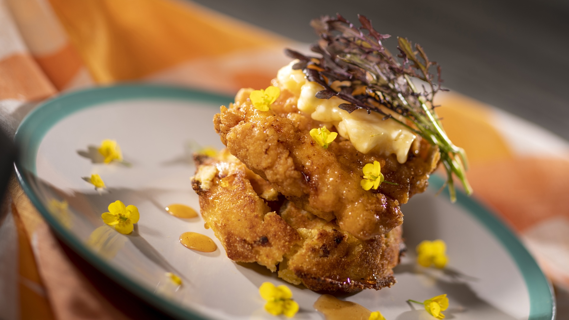 Chicken and Waffles: Crispy chicken and a sweet honey-bacon cornbread waffle with whipped honey butter and orange blossom honey