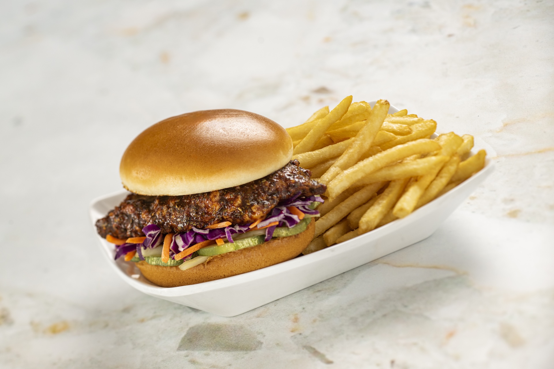 Hot Honey Chicken Sandwich: Southern fried chicken sandwich with hot honey, red cabbage slaw, and pickles on a brioche bun
