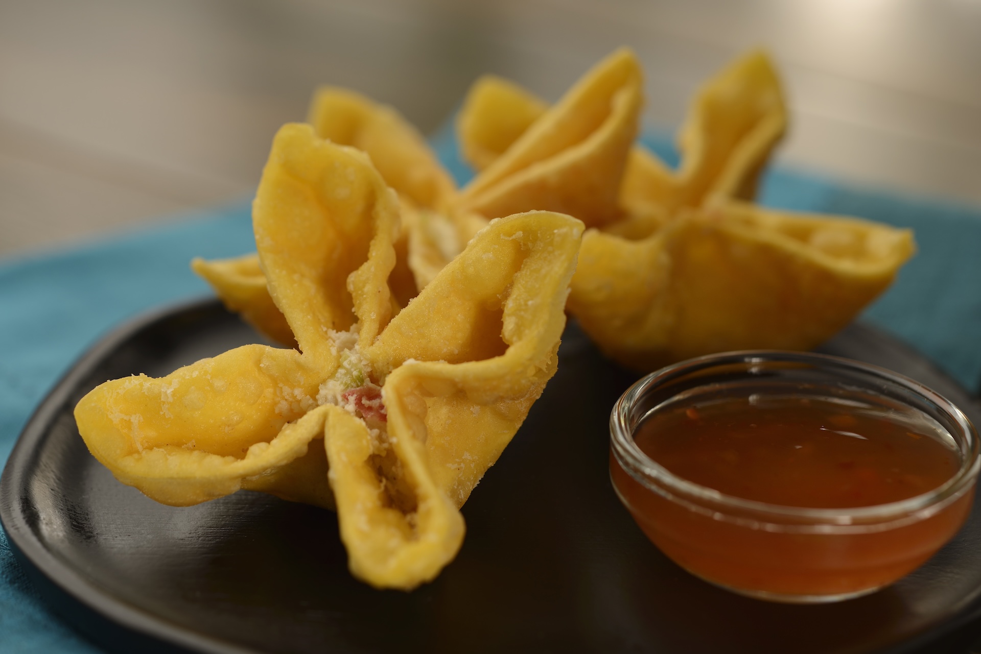 House-made Cheesy Crab Wontons: Fried wontons filled with cream cheese, celery, and imitation crab stick