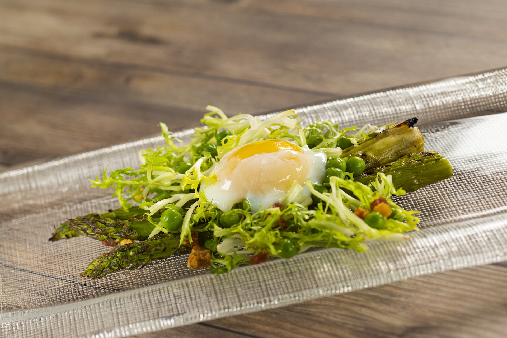 Grilled Asparagus with pancetta bacon, spring peas, fris&eacute;e lettuce, truffle sherry vinaigrette, and soft-poached egg