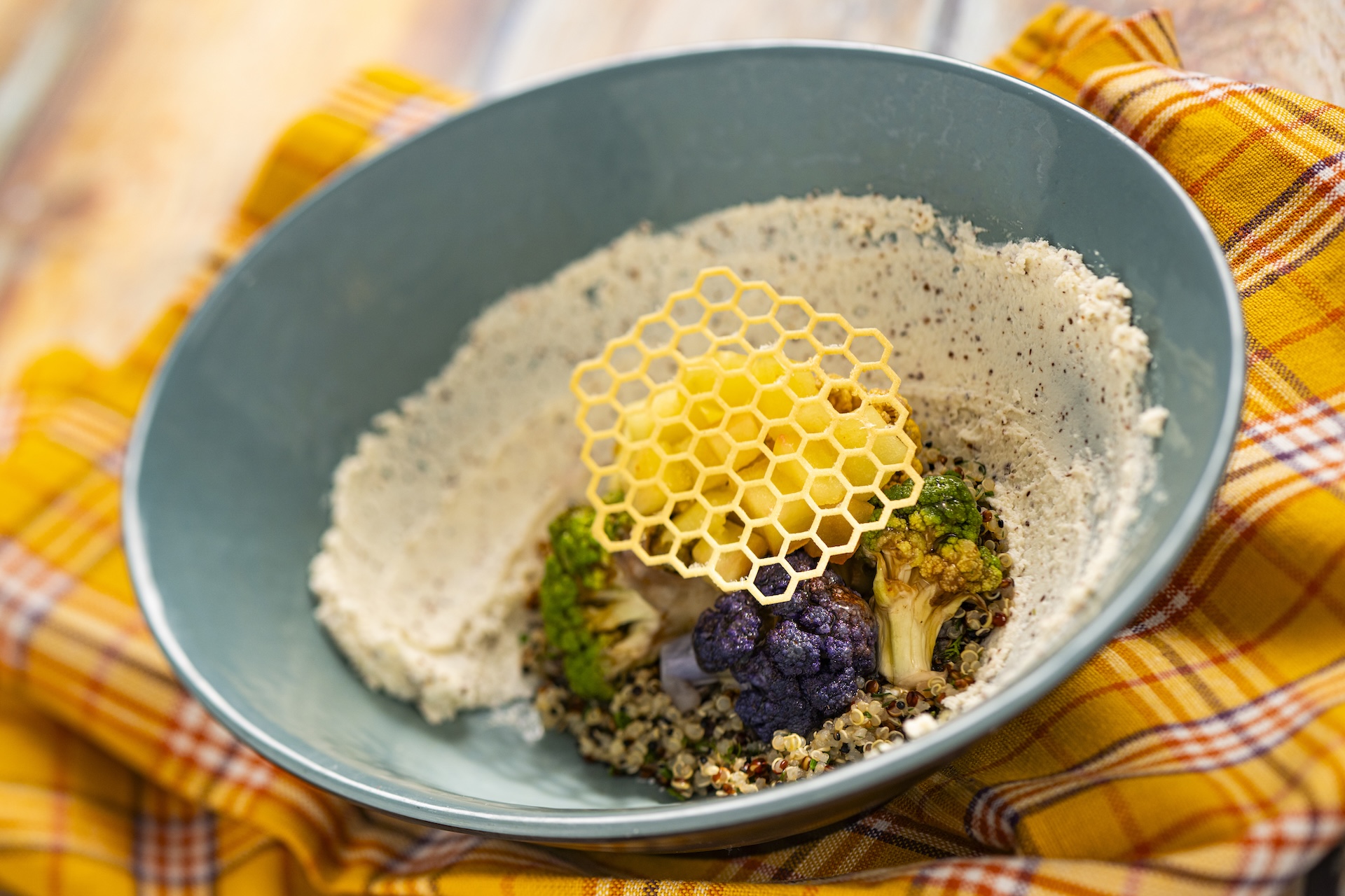 Honeycomb Bowl with herb quinoa, honey-whipped goat cheese, poached apples, and hot honey cauliflower topped with a honey tuile (New)