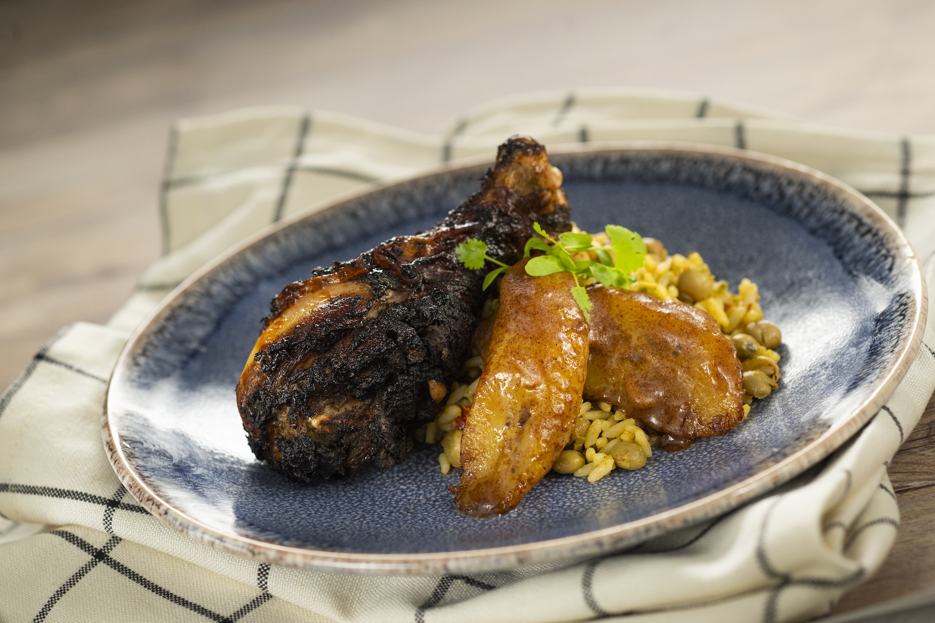 Jamaican Jerk Chicken with pigeon pea rice, roasted sweet plantains, and cinnamon butter