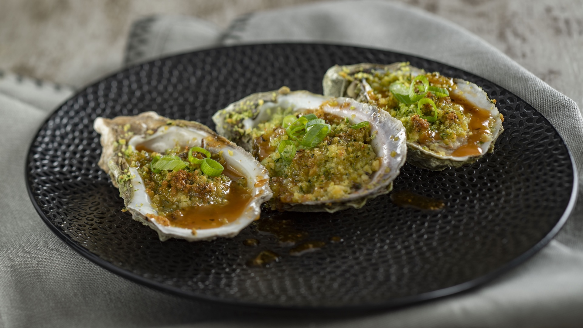 Grilled Gulf Oysters with andouille sausage butter and lemon
