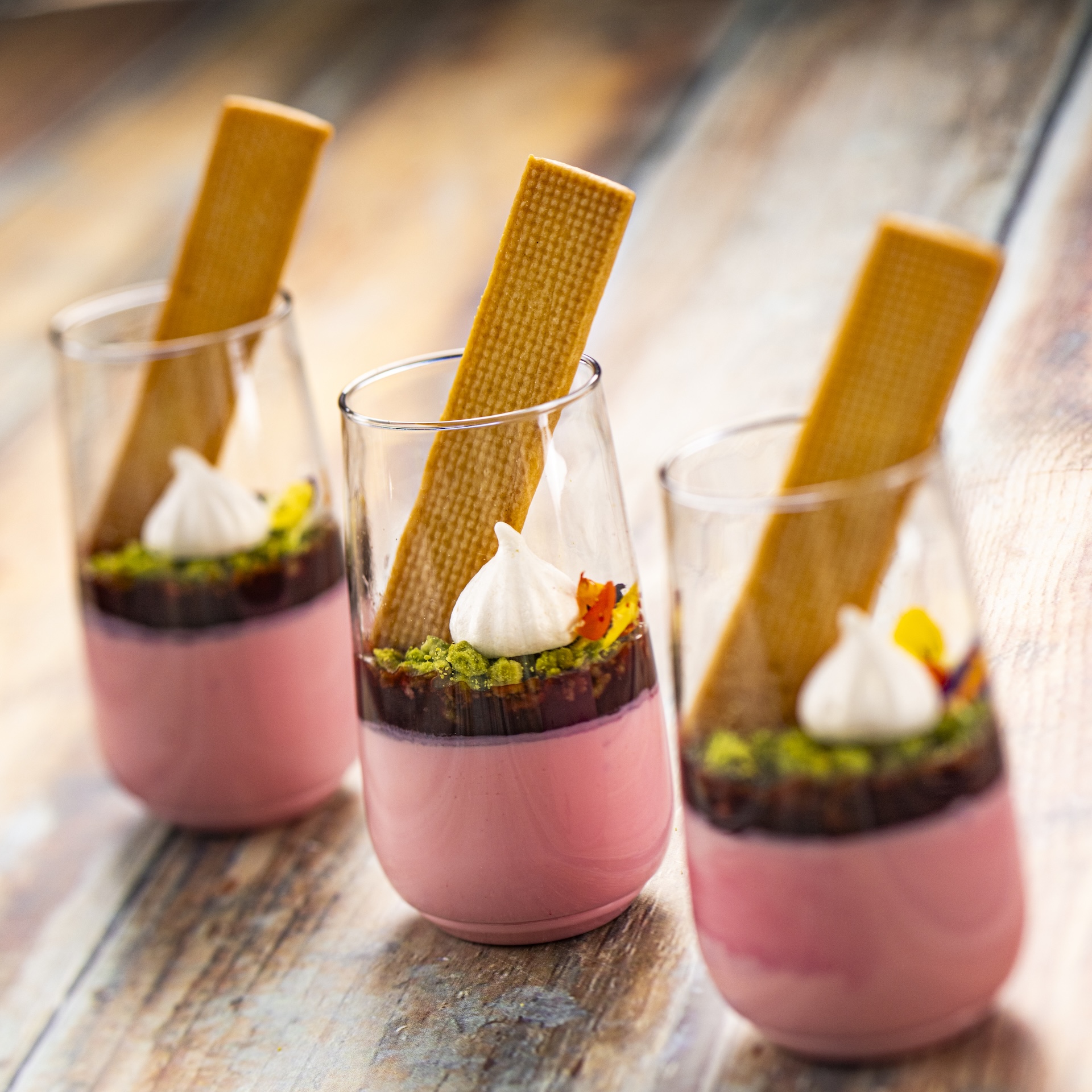 Coconut Panna Cotta with a cherry gel&eacute;e and matcha crumb topped with a citrus cookie, plant-based meringue, and flower confetti (Plant-based) (New)