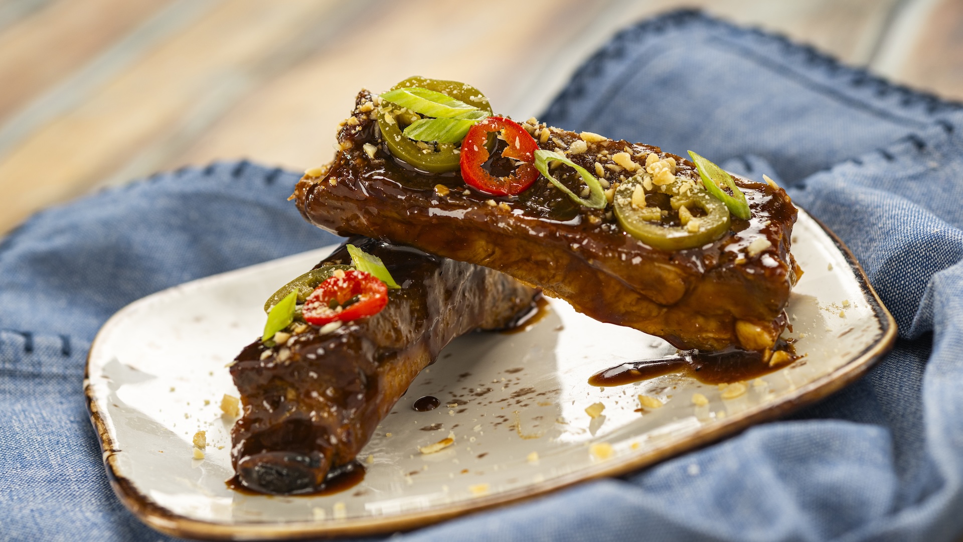 Miso Cola-glazed Sticky Pork Ribs topped with spicy pickled peppers and peanuts (New)
