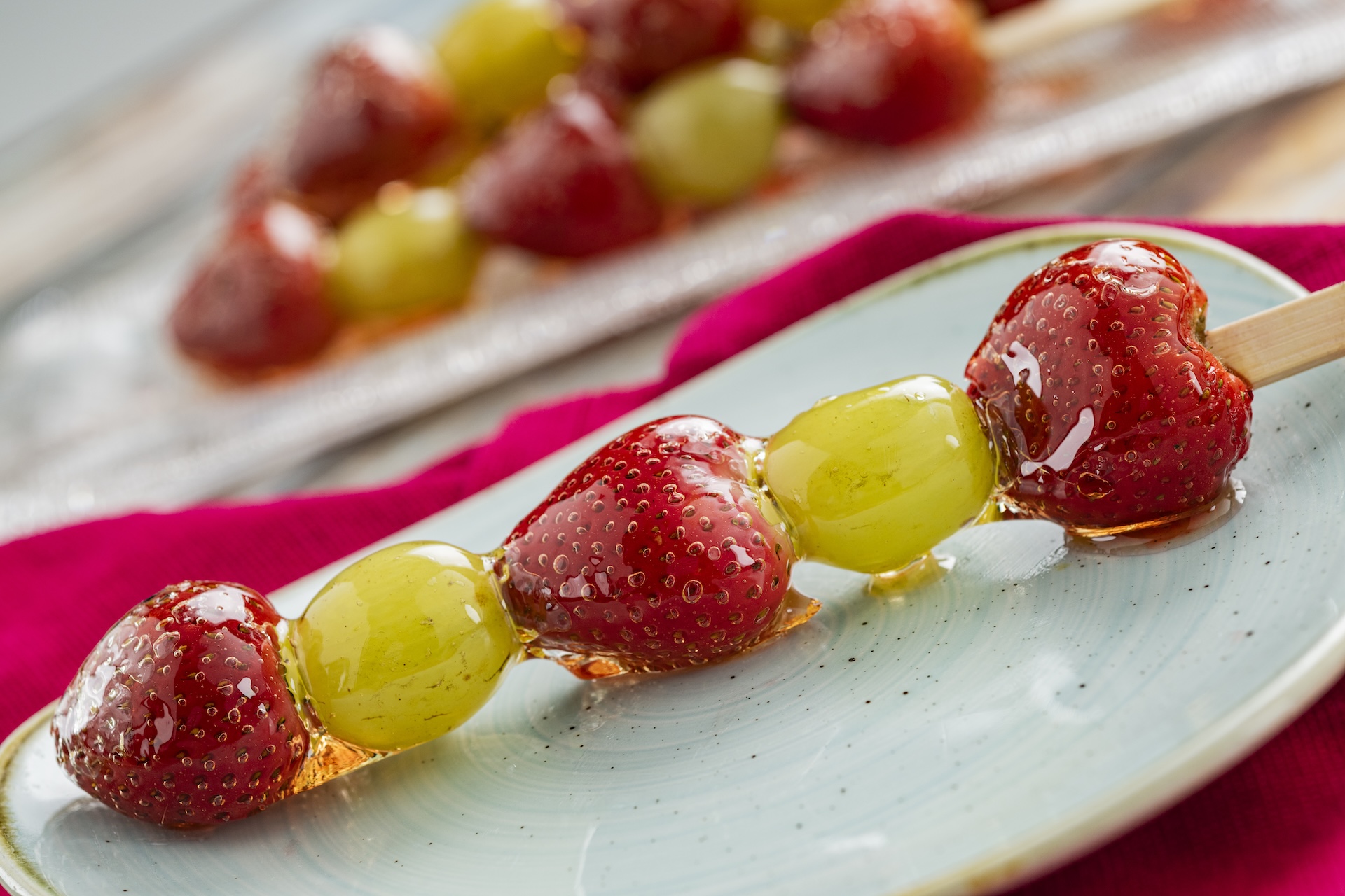 Tanghulu: Skewer of strawberries and grapes coated in candied sugar syrup (New)
