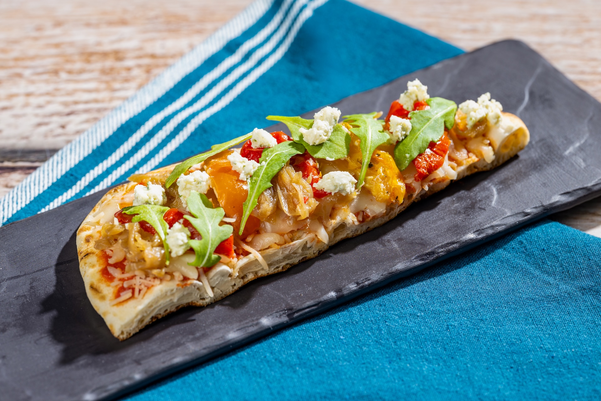 Garden Vegetable Flatbread featuring Boursin Crumbles Garlic & Fine Herbs Cheese topped with roasted vegetables and arugula salad (New)