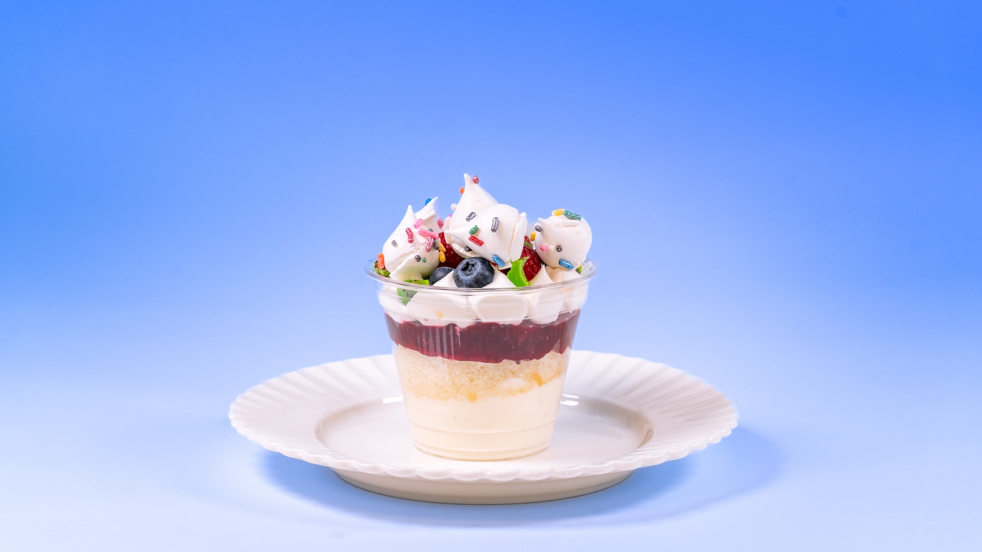Pavlova Parfait: Meringue bites, vanilla yogurt mousse, berry compote, vanilla cake, fresh berries, and candied kiwi (New)