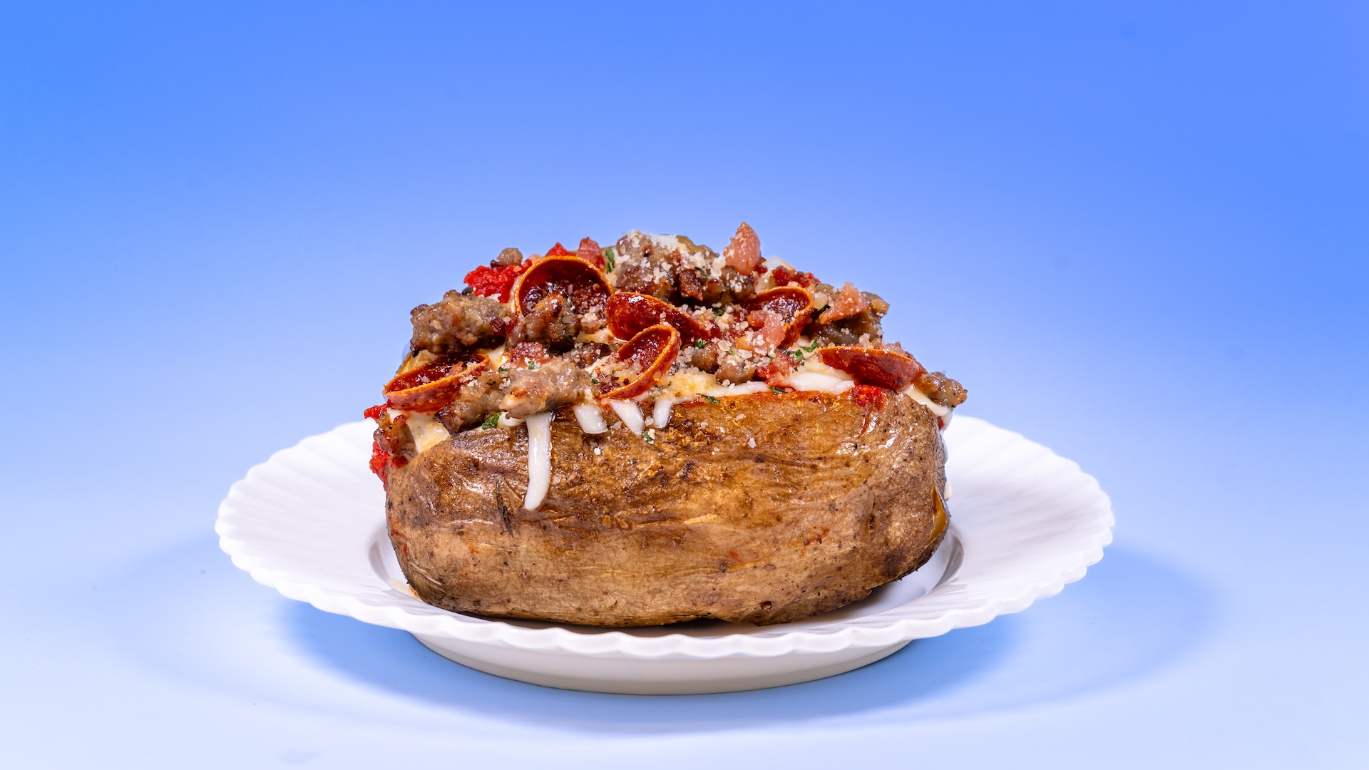 Pizza Girls Baked Potato: Pepperoni, sausage, bacon bits, marinara, mozzarella, alfredo sauce, and parmesan herb topper (New)