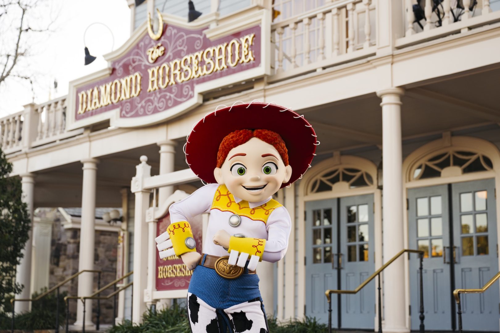 Jessie from Toy Story poses in front of the Diamond Horseshoe building.