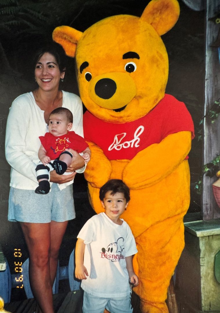 Reese with Winnie the Pooh at Disneyland