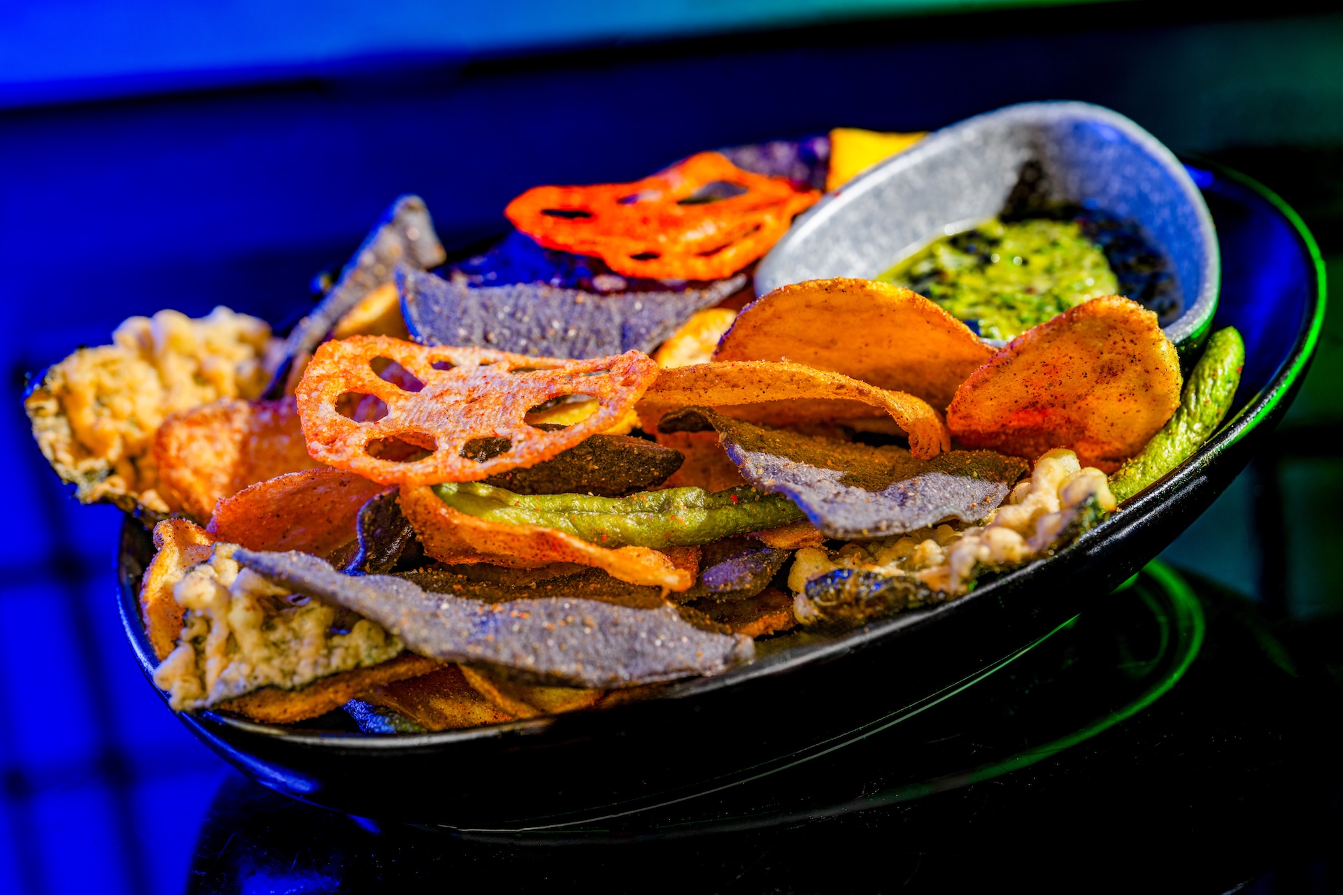 Batuu Bites: Blue corn, barbecue, and curry spice chips with lotus root, green bean chips, and herb dip