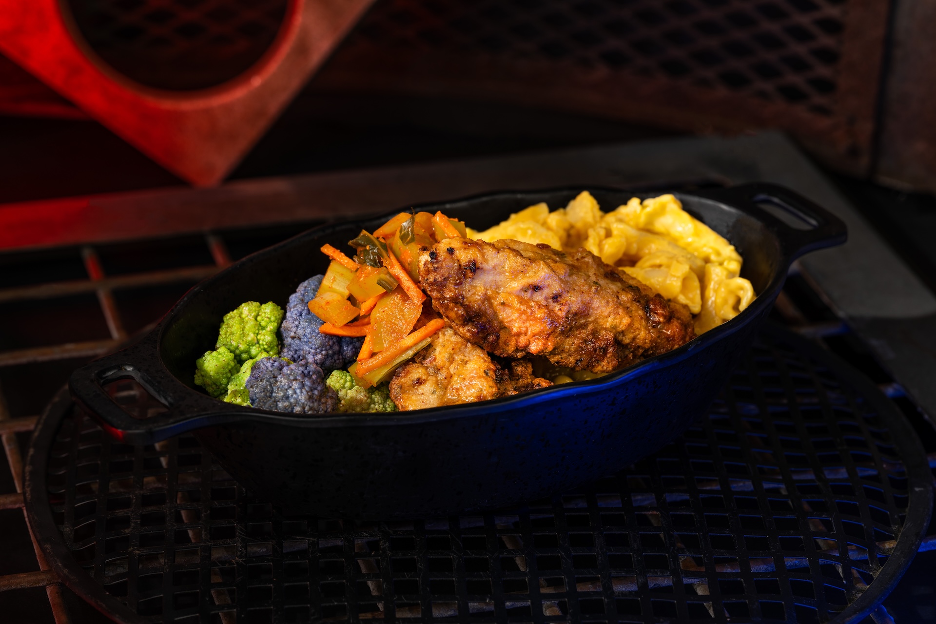 Endorian Fried Chicken Tip-Yip: Crispy chicken served with house-made macaroni and roasted vegetables garnished with cauliflower leaf kimchi