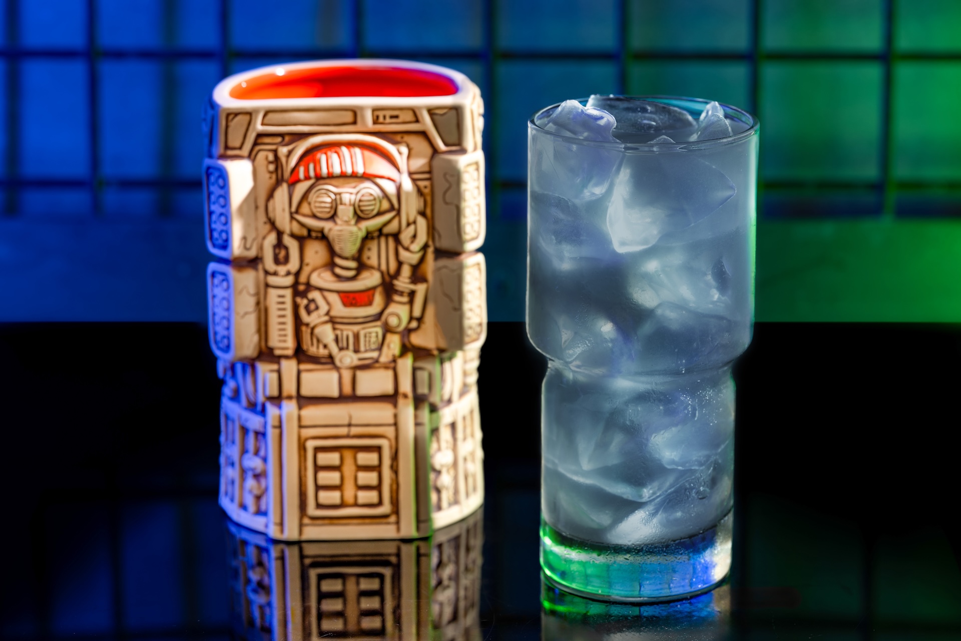 Kamino Cooler Served in DJ R-3x Souvenir Mug: Tito's Handmade Vodka, Bols Blue Curaçao Liqueur, passion fruit syrup, DOLE Pineapple Juice, and lime juice (New)