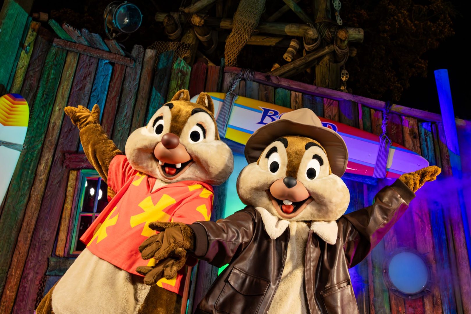 Chip and Dale in colorful costumes, posing joyfully at Typhoon Lagoon.
