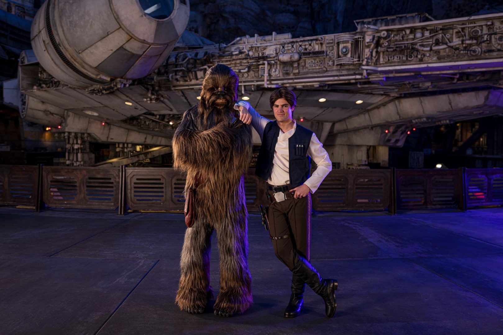 Han Solo and Chewbacca pose in front of the Millennium Falcon.