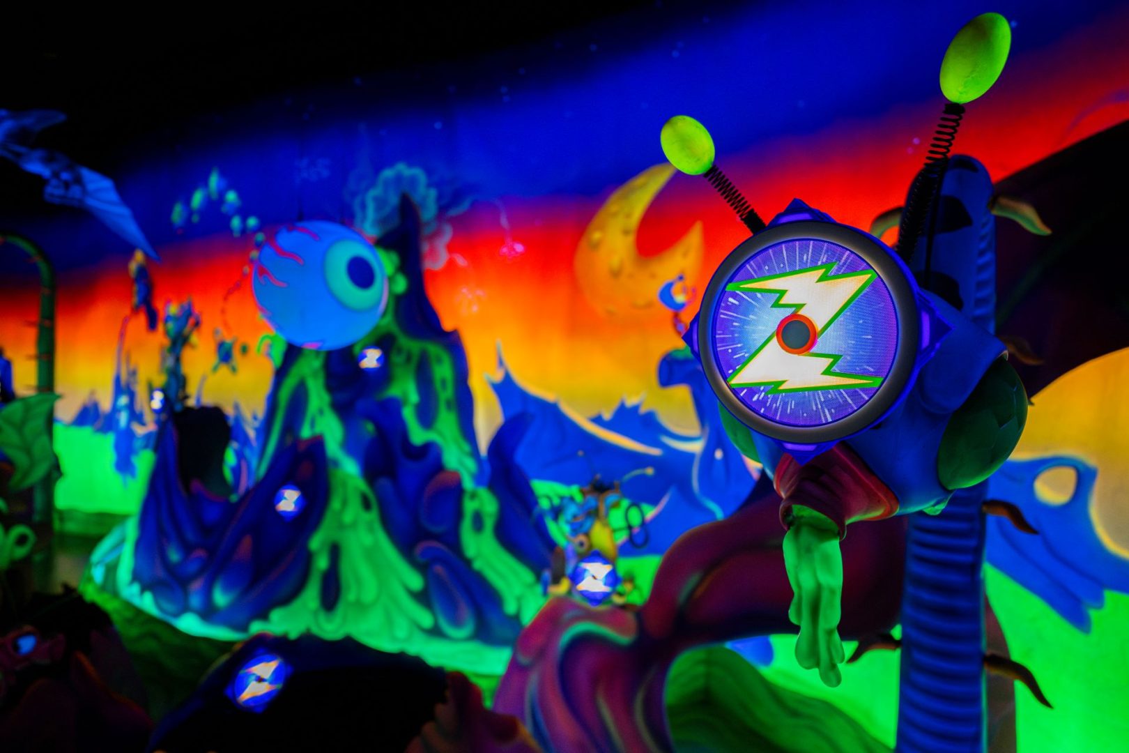 Colorful alien landscape with a glowing target display from Buzz Lightyear's attraction.