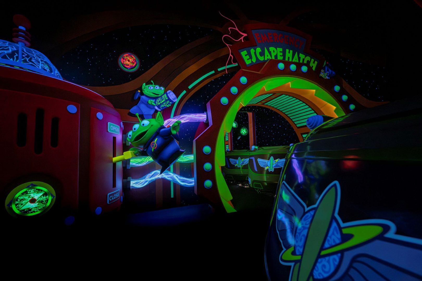 Colorful scene from Buzz Lightyear's Space Ranger Spin with animated aliens.