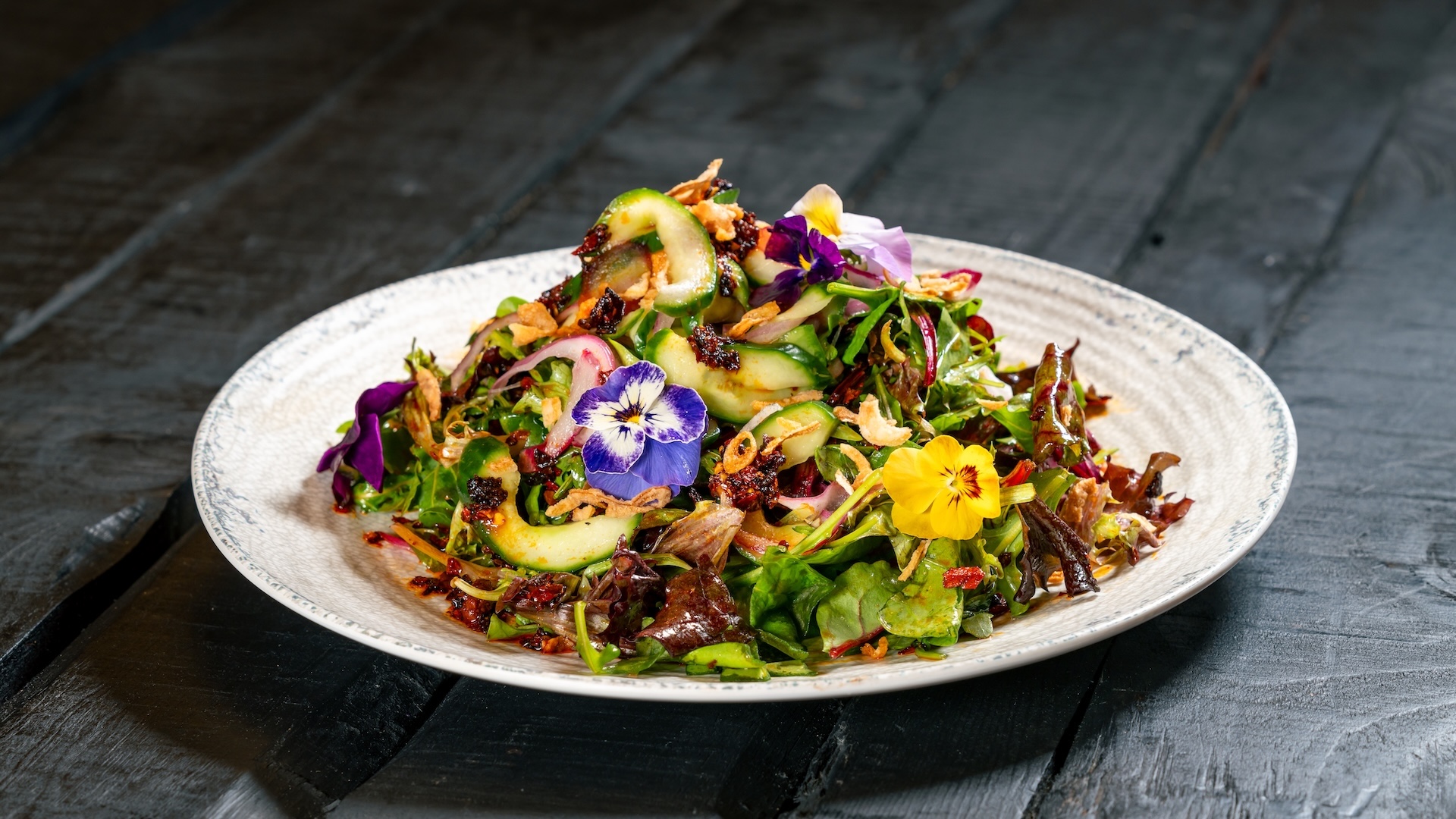 Trader Sam's Enchanted Tiki Bar Disneyland Hotel Island Chopped Salad: Crisp baby gem lettuce, smoked ham, green papaya, tropical fruit compote, cotija cheese, edamame, passion-orange-guava a&iuml;oli, and crispy fried shallots served with passion fruit vinaigrette
