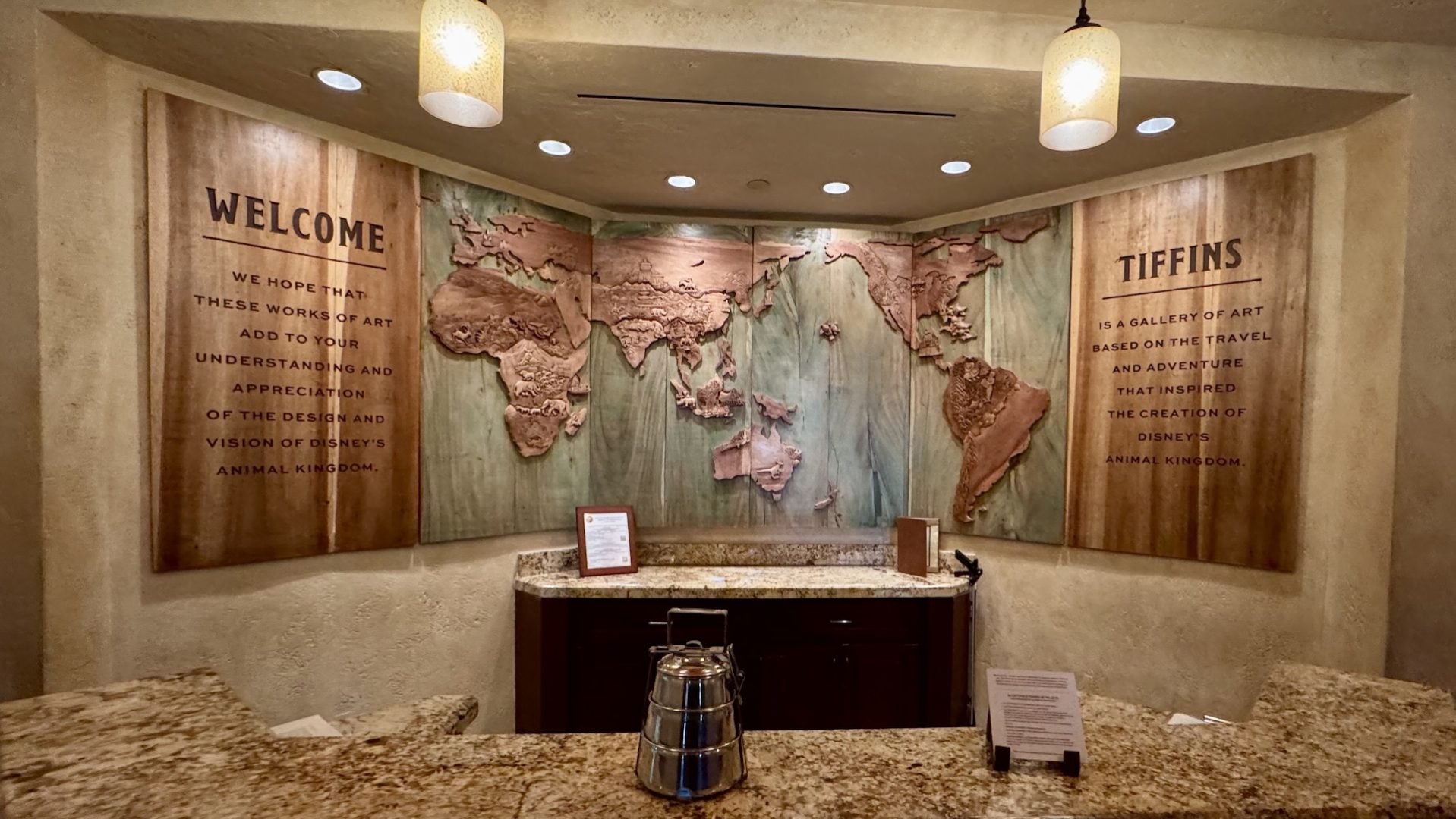Welcome area of Tiffins Restaurant featuring a world map art installation.