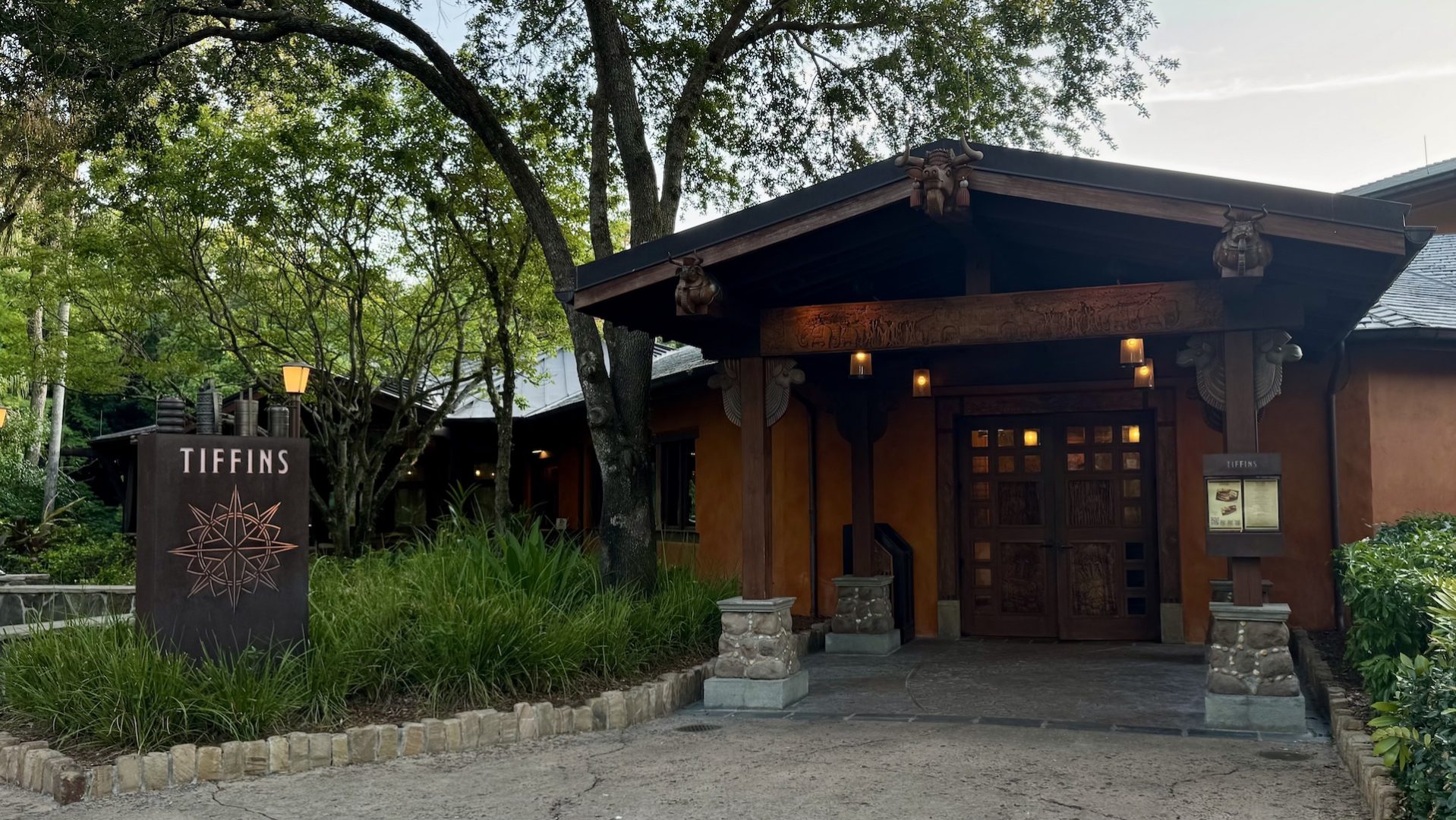 Entrance of Tiffins Restaurant at Disney’s Animal Kingdom, surrounded by greenery.