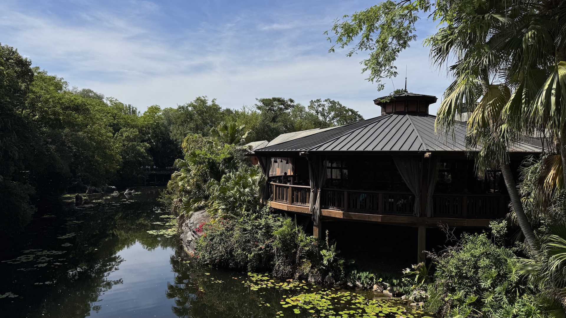 Tiffins Restaurant surrounded by lush greenery and water at Animal Kingdom.