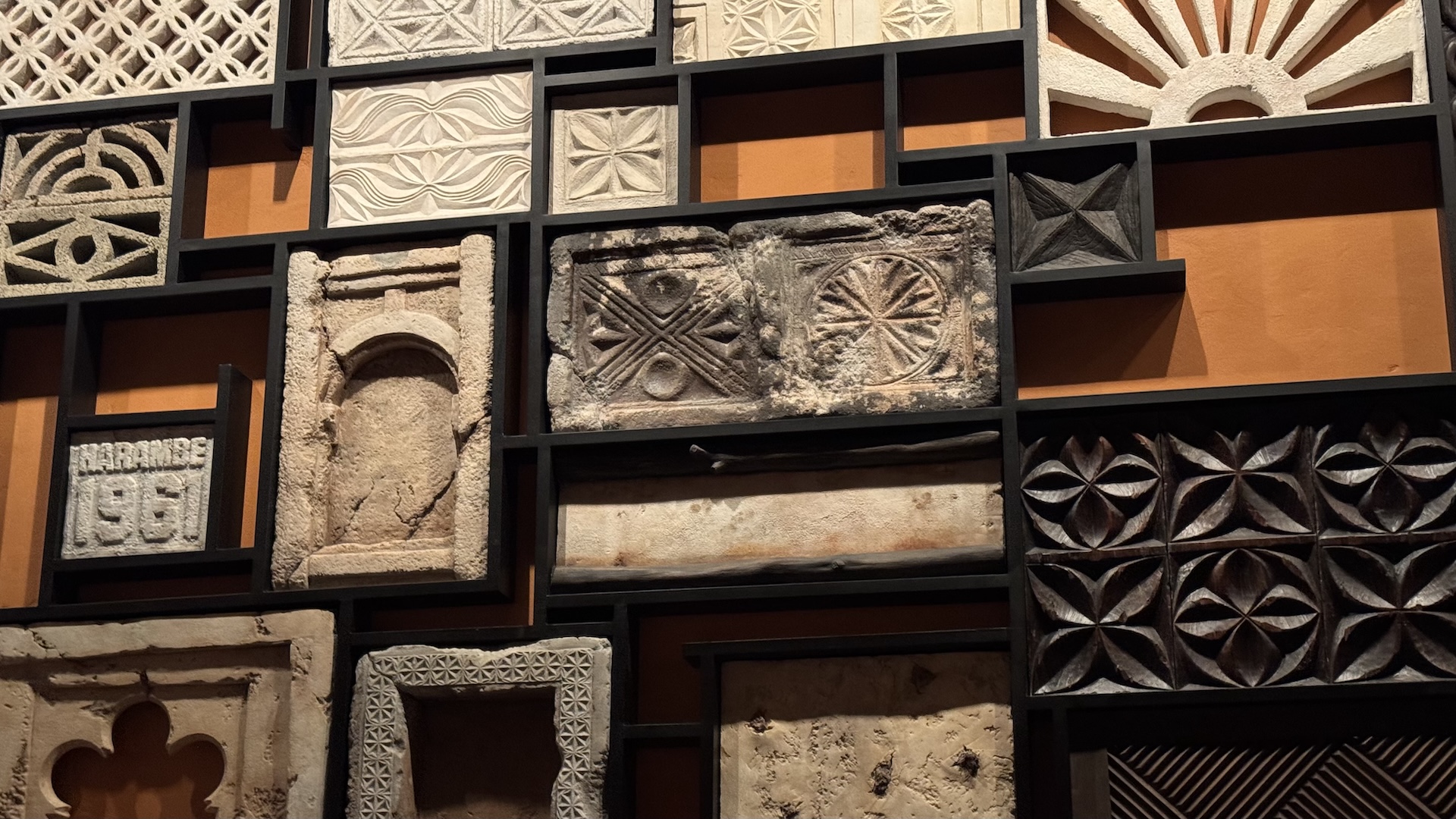Textured wall art featuring various patterns and designs in a grid layout.