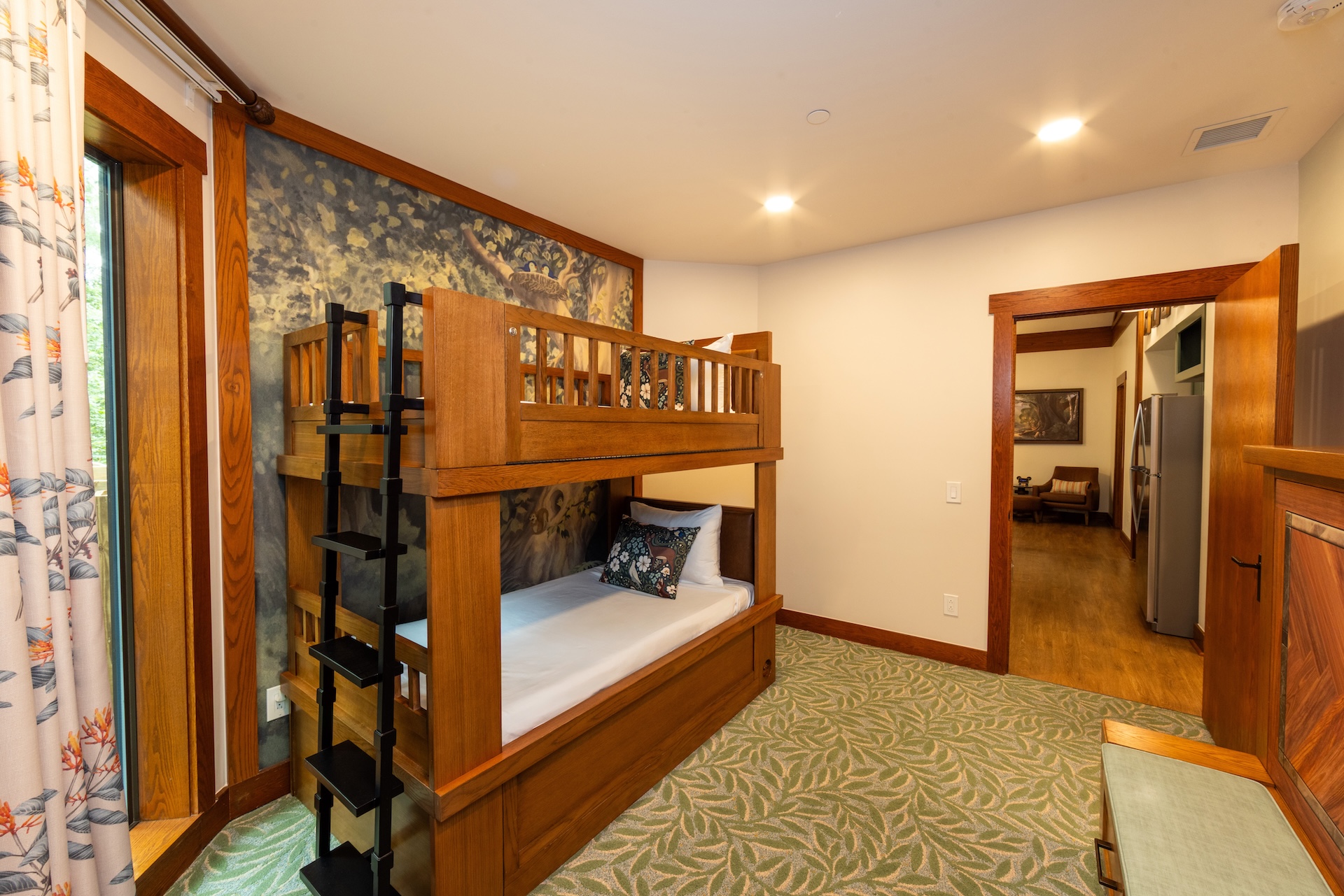 Bunk bed with ladder in a cozy resort room.