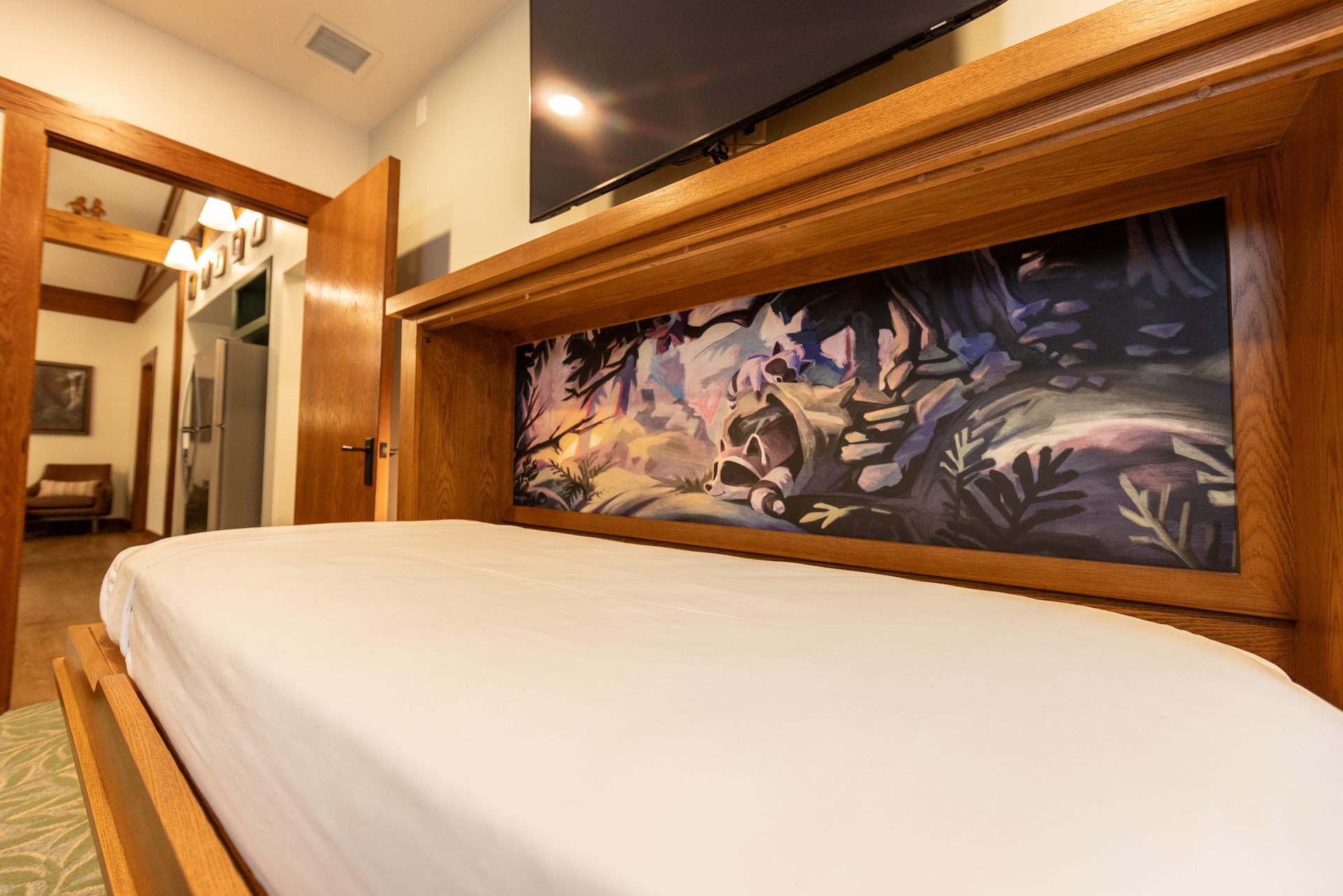 Interior view of a Treehouse Villa with wooden decor and raccoon artwork.