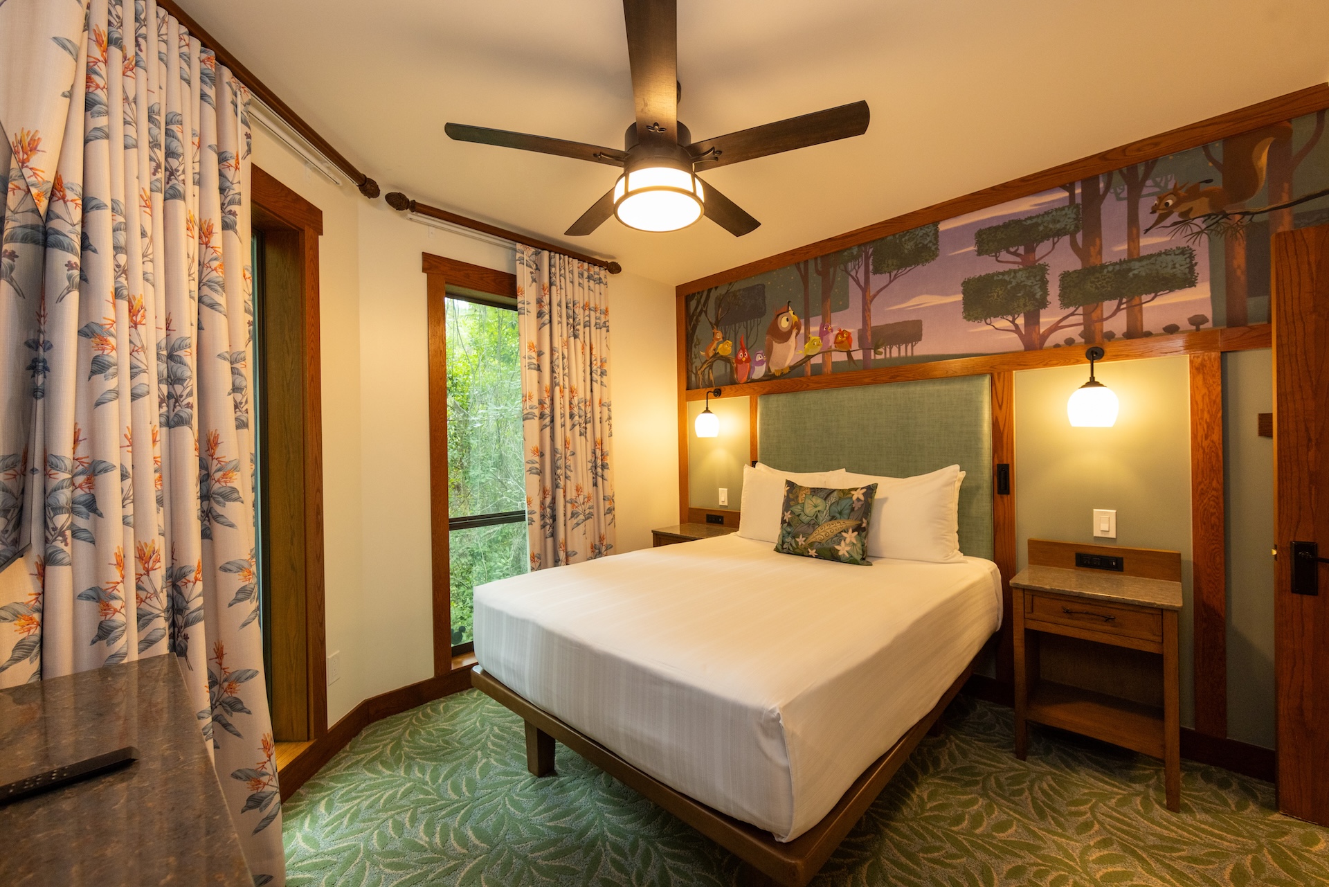 Cozy bedroom with a bed, colorful curtains, and nature-themed decor.