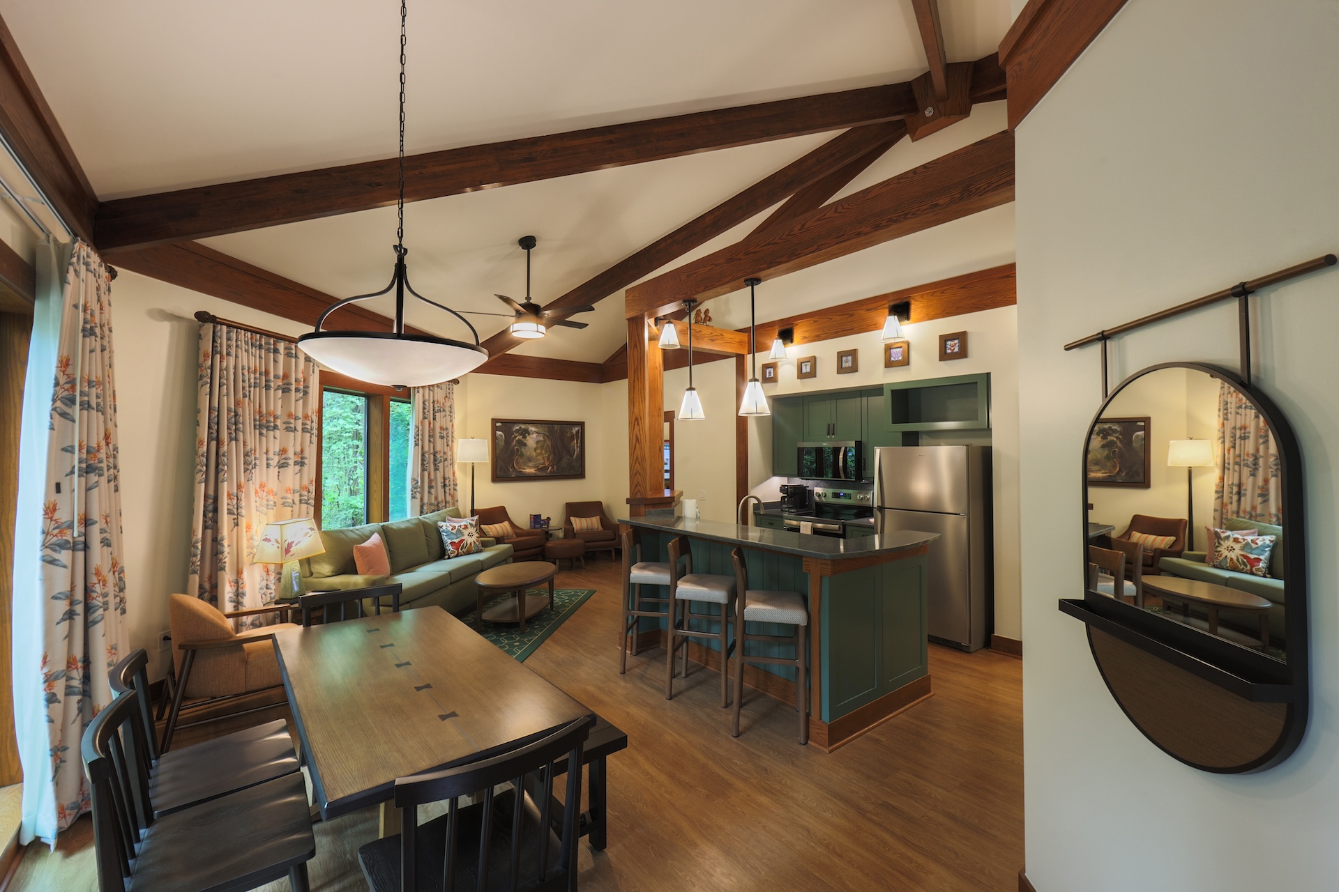 Cozy living area with kitchen, dining table, and large windows.