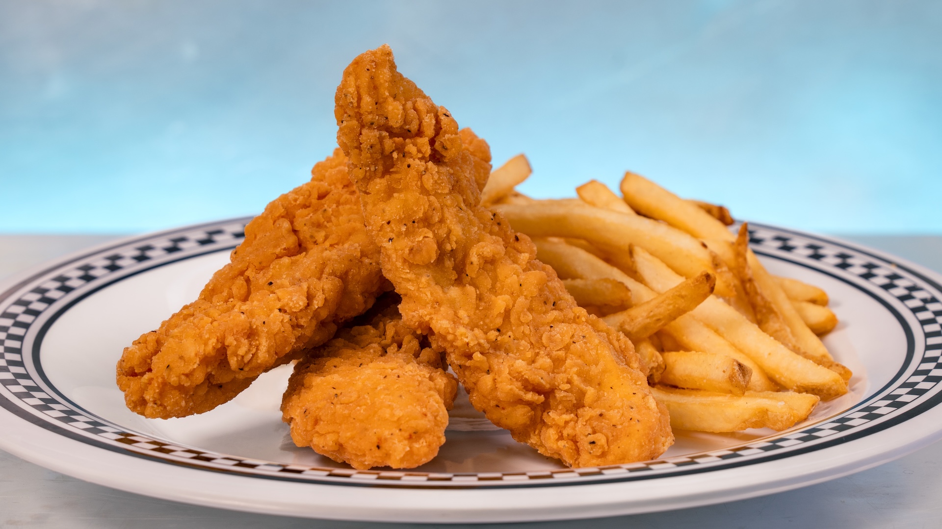 Disney Parks America 250 Foodie Guide Chicken Fenders: Crispy chicken strips with choice of Cuties Mandarin Oranges or fries