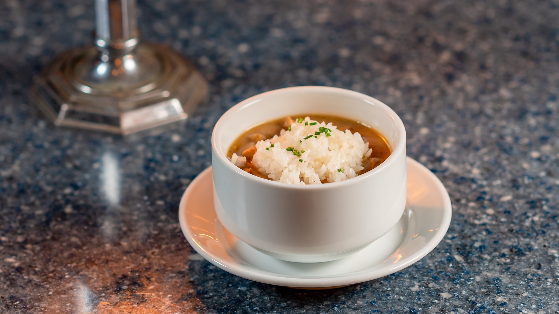 Disney Parks America 250 Foodie Guide Gumbo: Chicken, Tasso ham, andouille sausage, and peppers with steamed rice