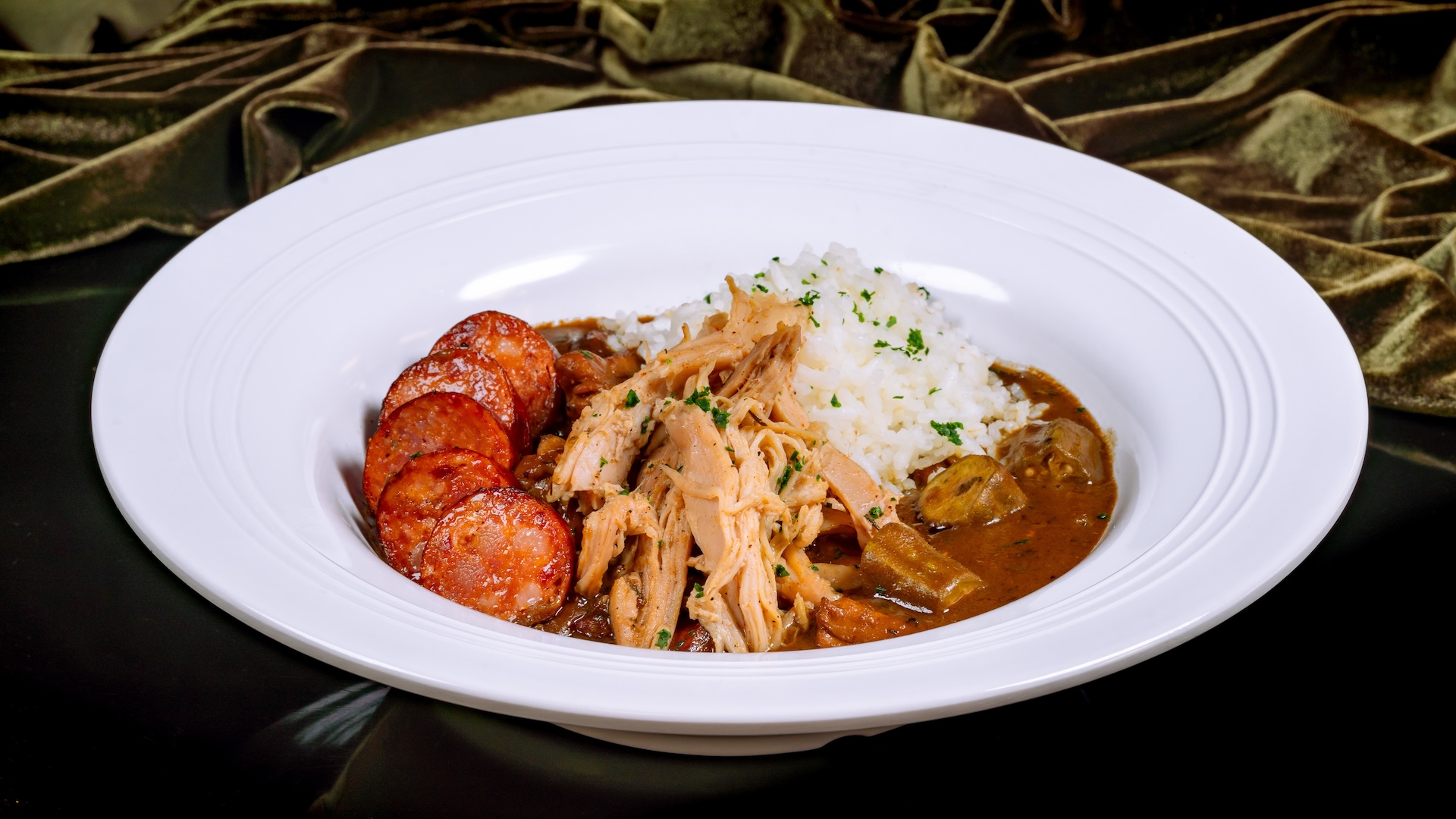 Disney Parks America 250 Foodie Guide House Gumbo: Braised chicken, andouille sausage, and heirloom rice