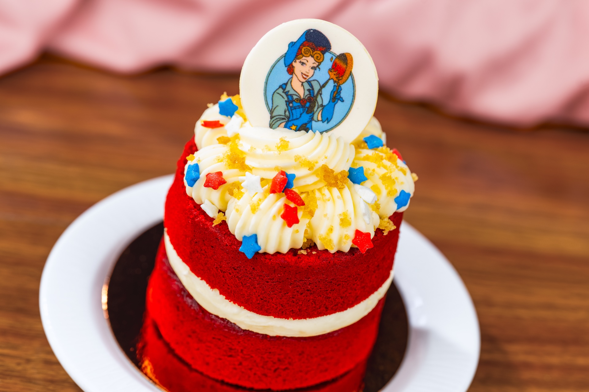 Red Velvet Riveter: Red velvet cake with fudge filling topped with cream cheese icing, ginger streusel, star sprinkles, and a chocolate piece 